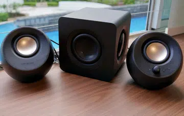 The Creative Pebble X Plus consists of two compact satellite speakers and a larger subwoofer.