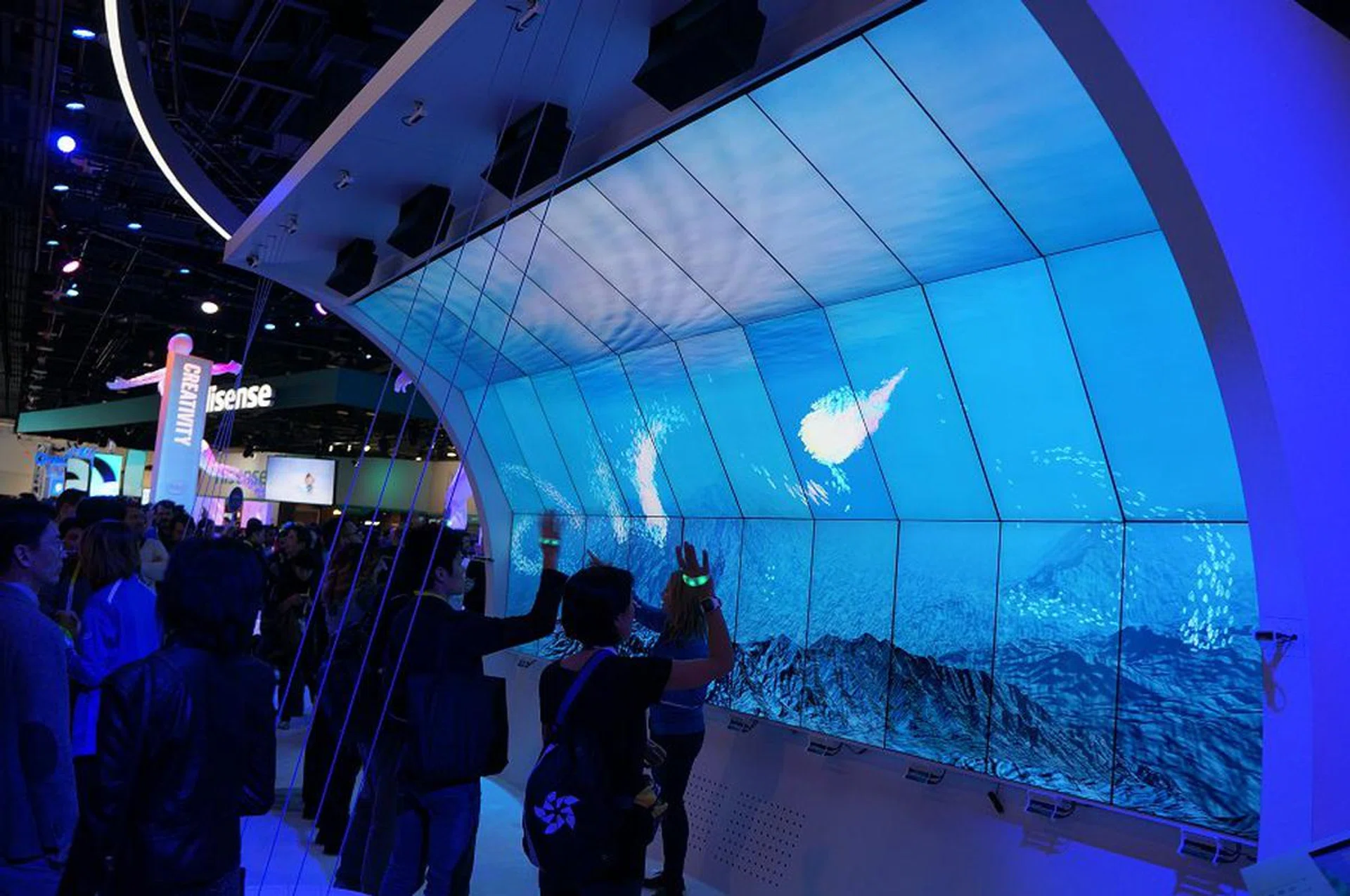 Schooling fish via ‘crowdsourcing’. The more the participants wave their hands with the band on their hand, the more they attract the fishes to travel towards their way.