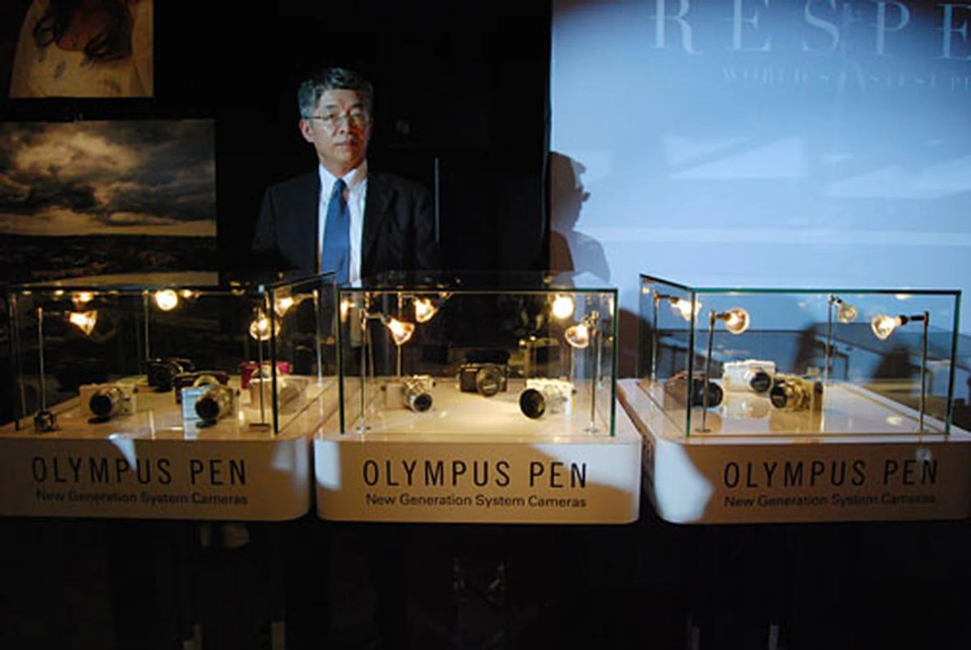 Hirofumi Imano, General Manager, Design Center, Olympus, unveils the three PEN cameras.