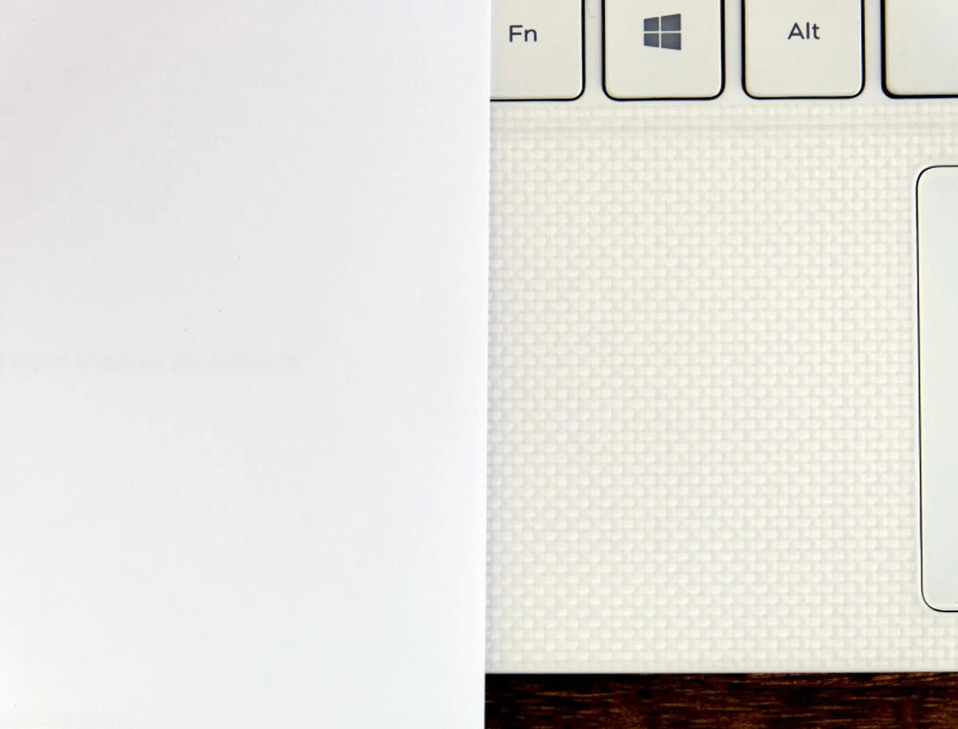 Here's a piece of paper juxtaposed with the 'alpine white woven glass fiber' palm rest of the XPS 13. I leave you to make your own conclusions.