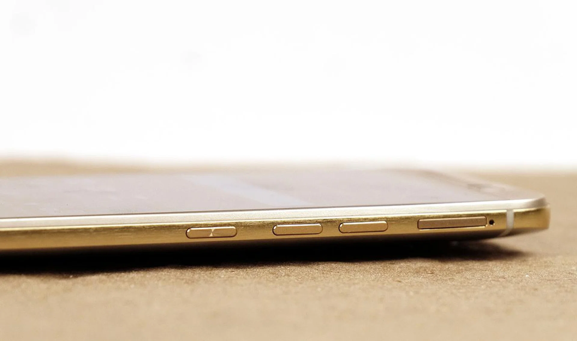 The power button has been relocated to the side of the phone, beneath the volume buttons. It has a light circular etching to give it a different tactile feel from the volume buttons.