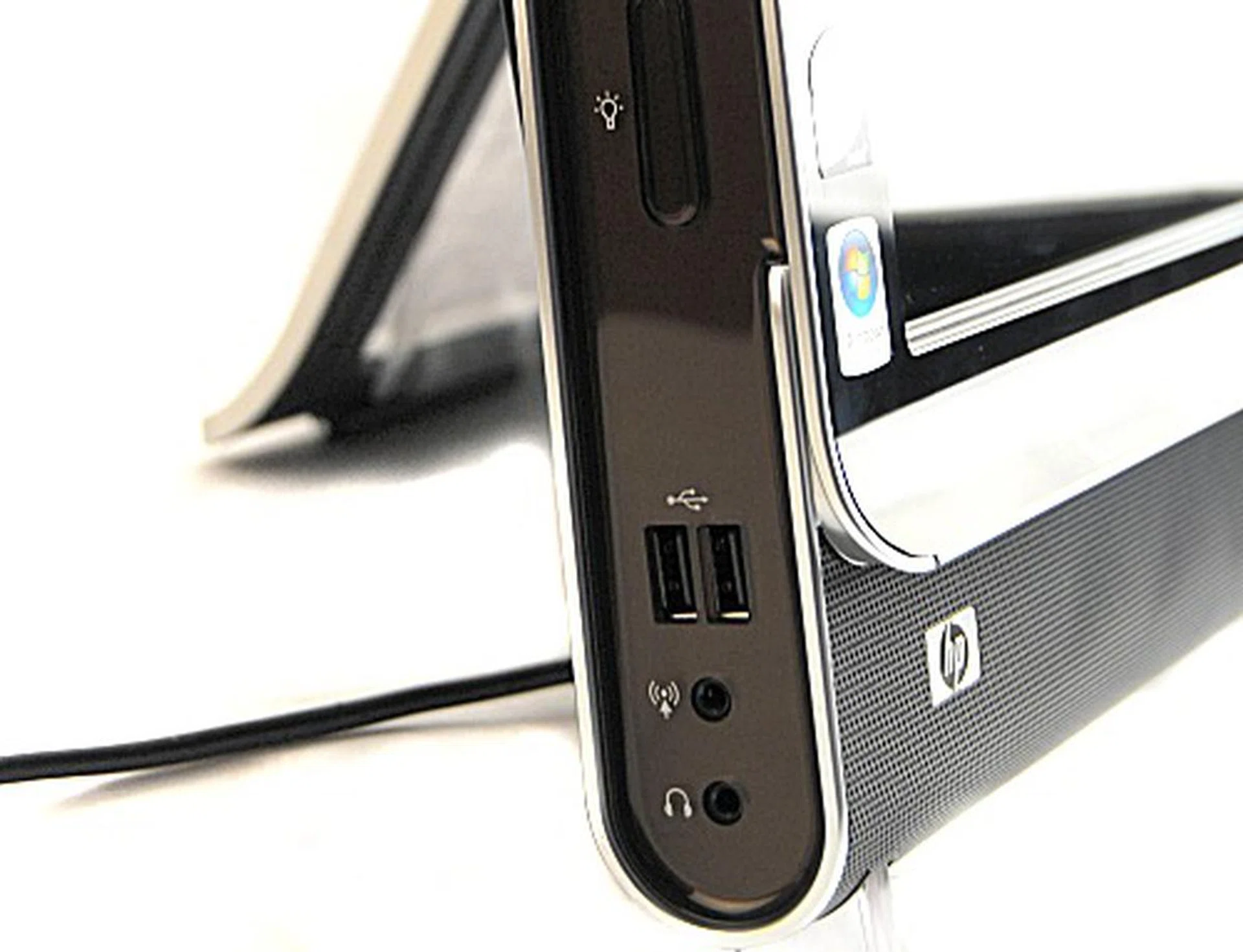 A closer look at the bottom of the unit reveals two USB 2.0 ports, the headphone and microphone jacks and a button to control the lights for helping you type in the dark (as seen during our preview ).