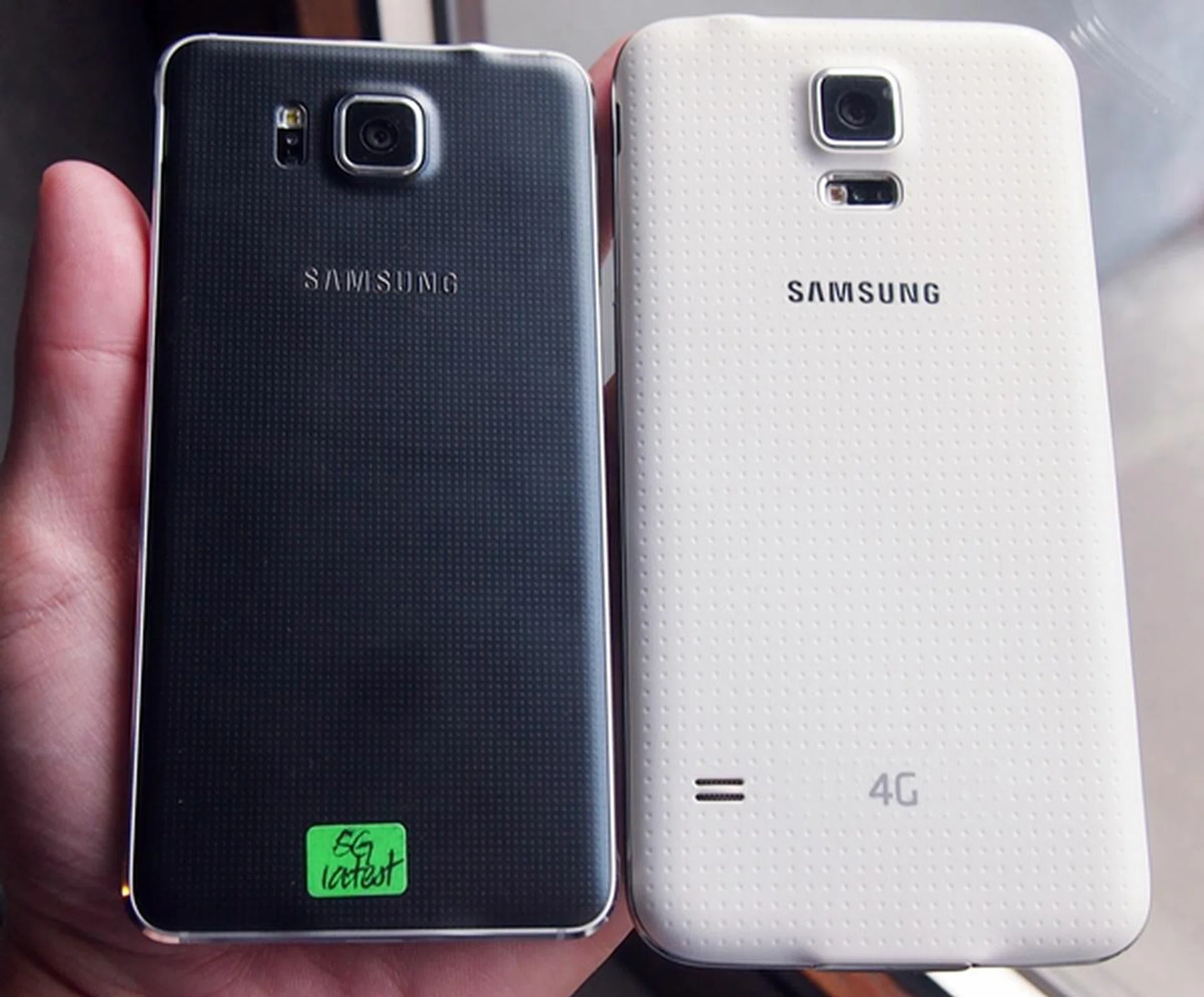 Compared to the Samsung Galaxy S5 (right), the Galaxy Alpha (left) sports a finer dotted pattern on its rear cover.