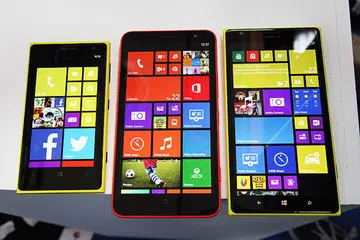The new Nokia Lumia 1320 (center) and Lumia 1520 (right) smartphones that feature a large 6-inch screen compared with the 4.5-inch Lumia 1020 (left). It's apparent from this that the new devices now feature an extra column of tiles that gives you even more space to put your favorite apps on your home screen.
