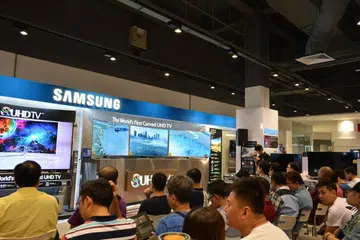 Participants being treated to a triple-display setup of the 65-inch Samsung JS9500 while waiting for the event to start.