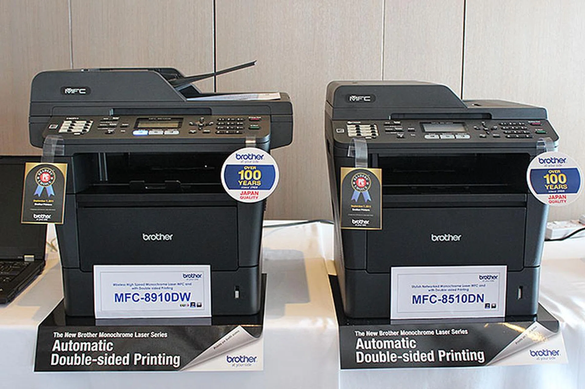 For S$1,088, the MFC-8910DW (left) gives you 40ppm print speed, up to 800 sheets paper input capacity, a 50-sheet duplexing ADF, and wireless connectivity.