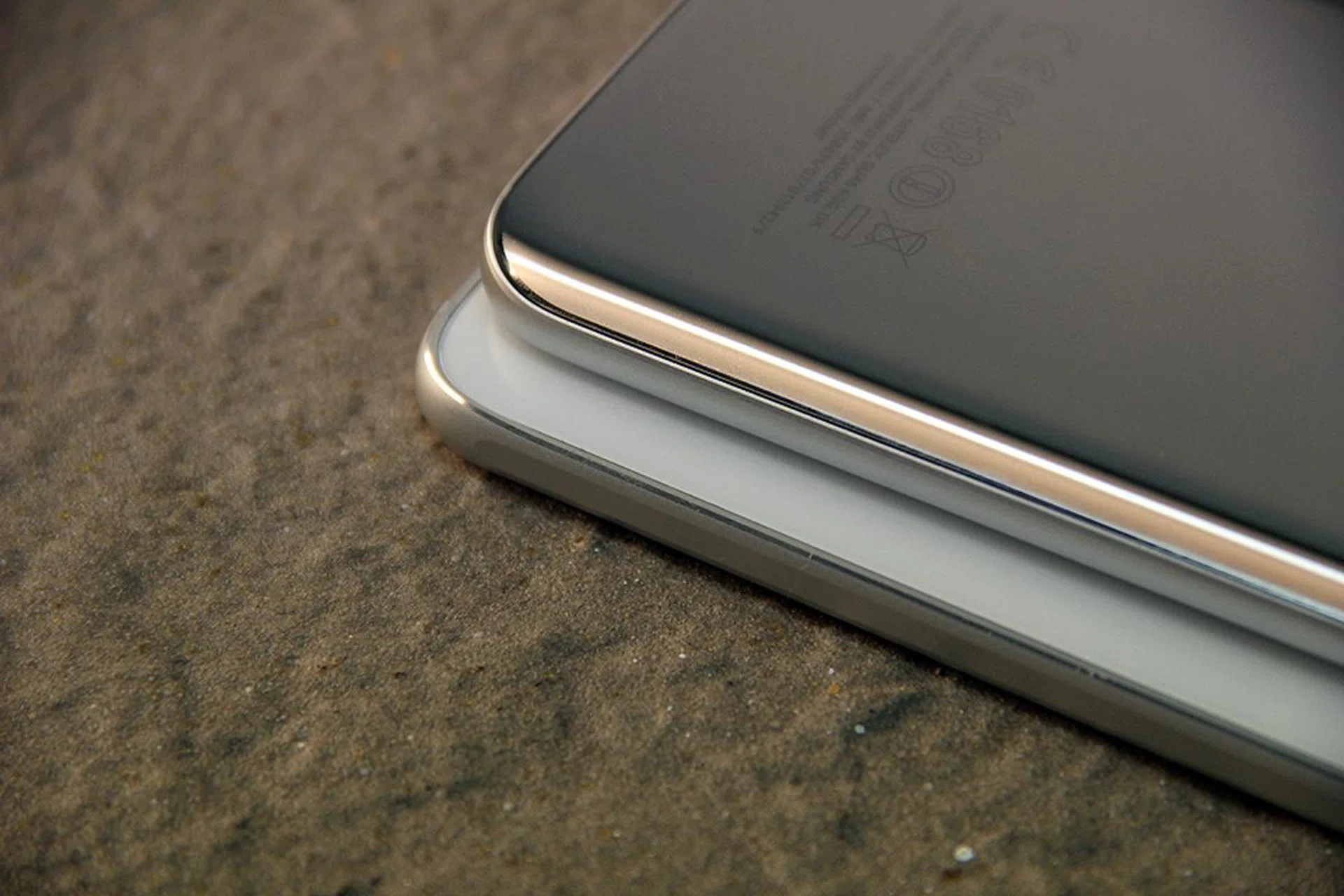 Stacking the Galaxy S7 on top of the Galaxy S6 reveals the key difference in design between these two units. Notice that the newer unit comes with curved sides, as opposed to the relatively angular S6 design.