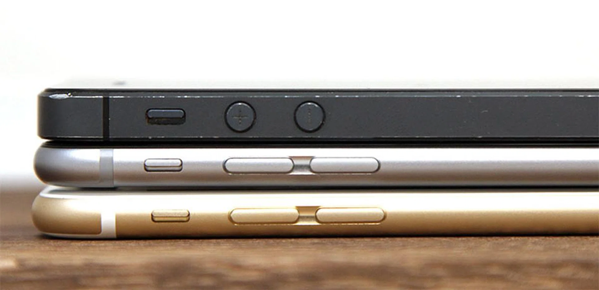 Despite being just 5 and 7mm thicker, the iPhone 5 (top) looks massive lying on top of the iPhone 6 (middle) and 6 Plus (bottom).
