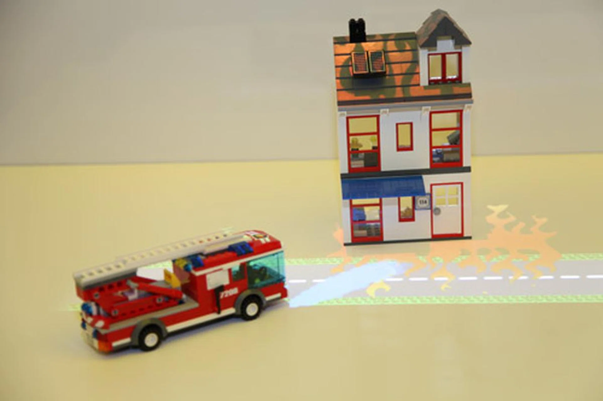 Intel further refined their object recognition technical demo using a more powerful Sandy Bridge desktop processor. A camera overhead recognizes objects and interacts with them by projecting images on the objects via an overhead projector.