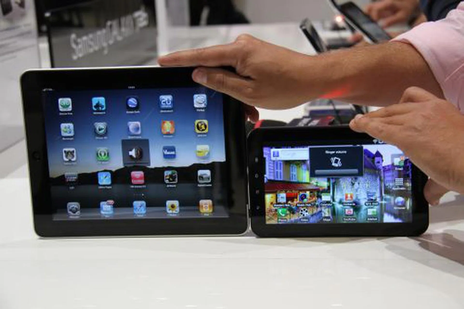 Here's an image comparing the Tab with the Apple iPad (left). The Tab uses a Super TFT screen and comes with a 30-pin charging connector that supports HDMI  as well. So far, Samsung will only distribute the Galaxy Tab via telecom operators (no retail version).