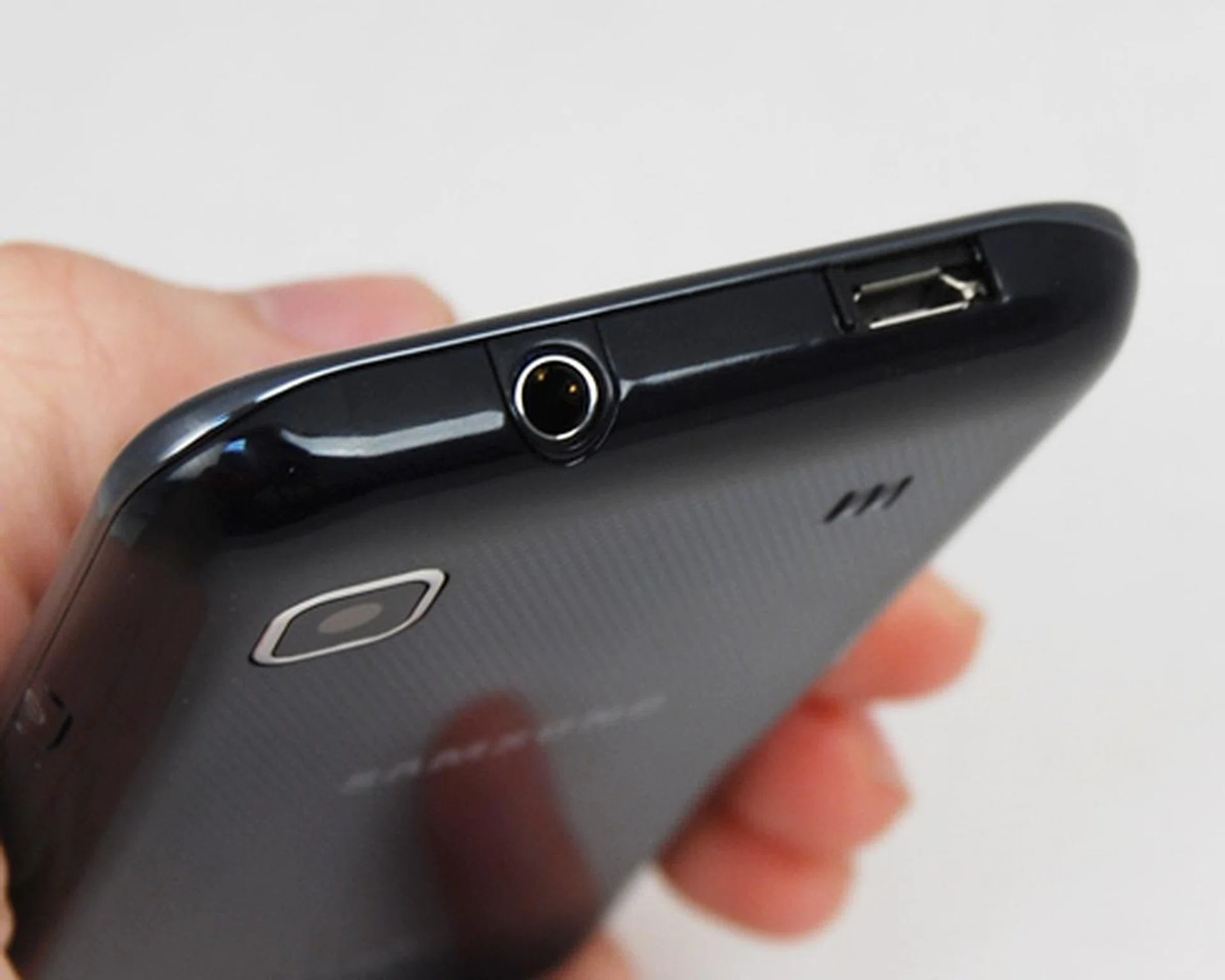 A microUSB port with a sliding cover, sharing space with the 3.5mm audio jack.