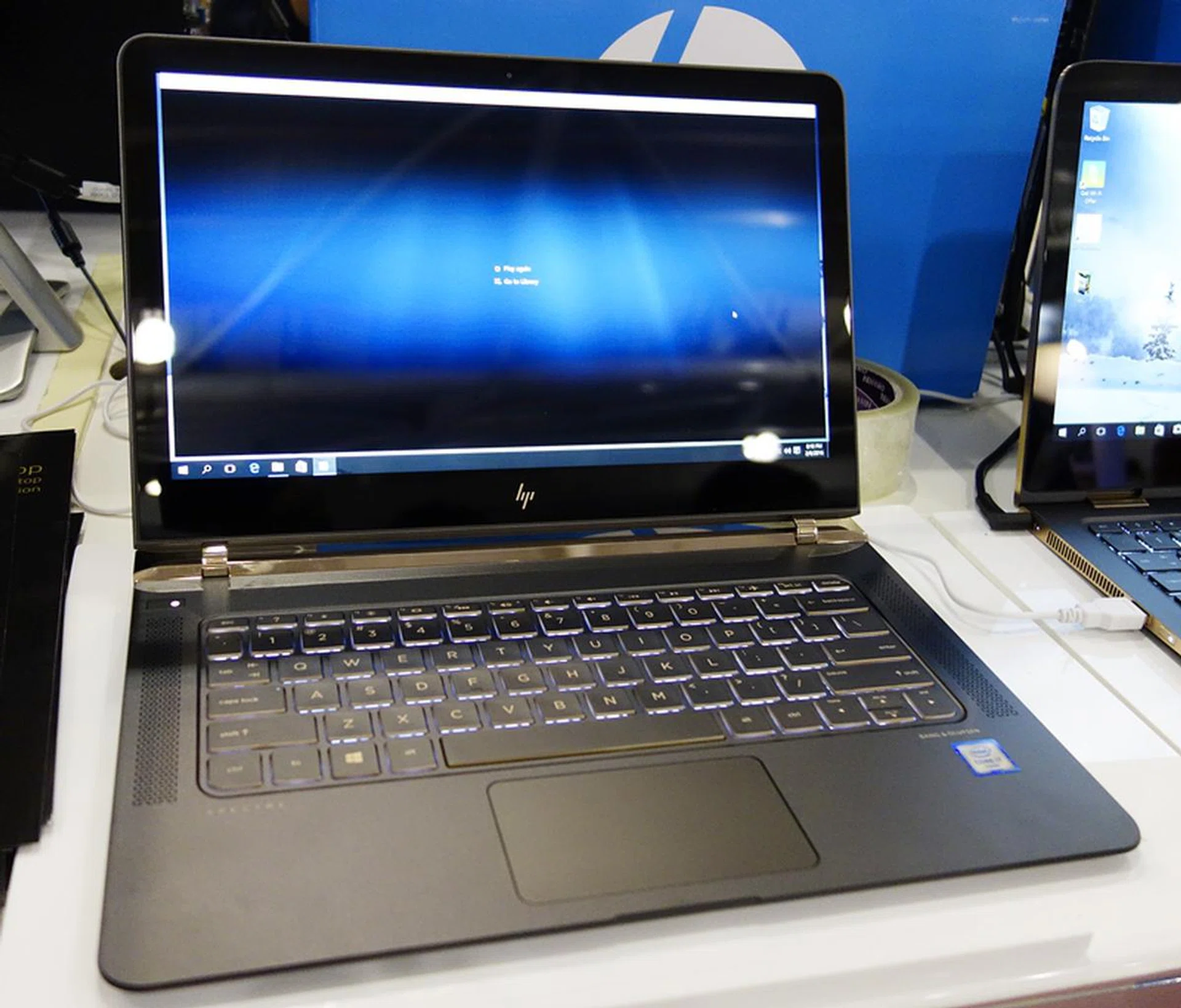 The new 13.3” HP Spectre is a mere 10.4mm thick and comes a 1,920 x 1,080-pixel IPS display, with 8GB of RAM, and 256GB of SSD storage. Powered by the 6th generation Intel Core i5-6200U CPU, it features a total of three USB Type-C ports, of which two support Thunderbolt 3. This configuration will cost you $2,299. For the higher-specced version that comes with an Intel Core i7-6500U CPU, with 8GB of system memory, and a 512GB SSD, the notebook will cost an additional $300, at $2,599.   The free gift bundle includes a HP Premium Executive Brown Topload (worth $149), a 1-Year McAfee Internet Security subscription (worth $39), and a HP 2nd year local onsite warranty with third Business Day Response (UM952E, worth $229).