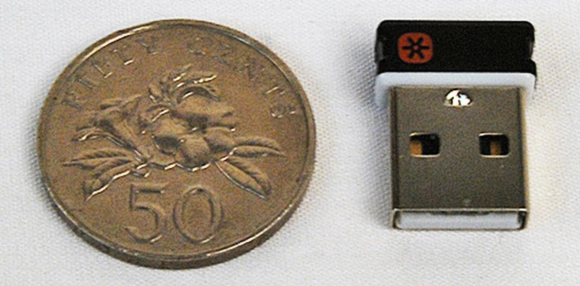 The unifying receiver can sync with multiple Logitech wireless devices, saving precious USB slots. Here it is with a Singapore 50 cent coin for scale.