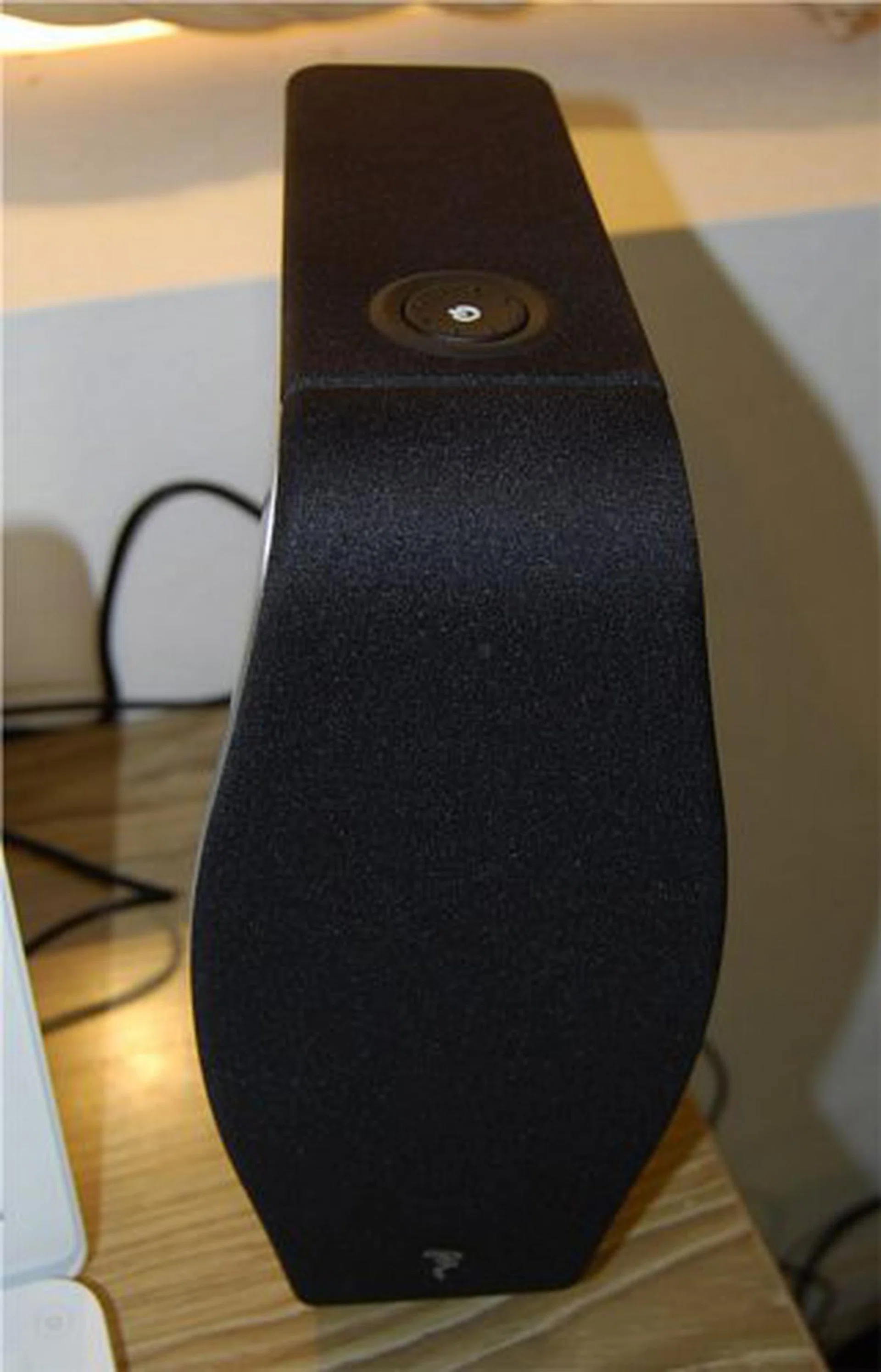 The master unit has a power button on the top and is connected to the slave by an RCA cable. The XS Book is a pure analog speaker system.