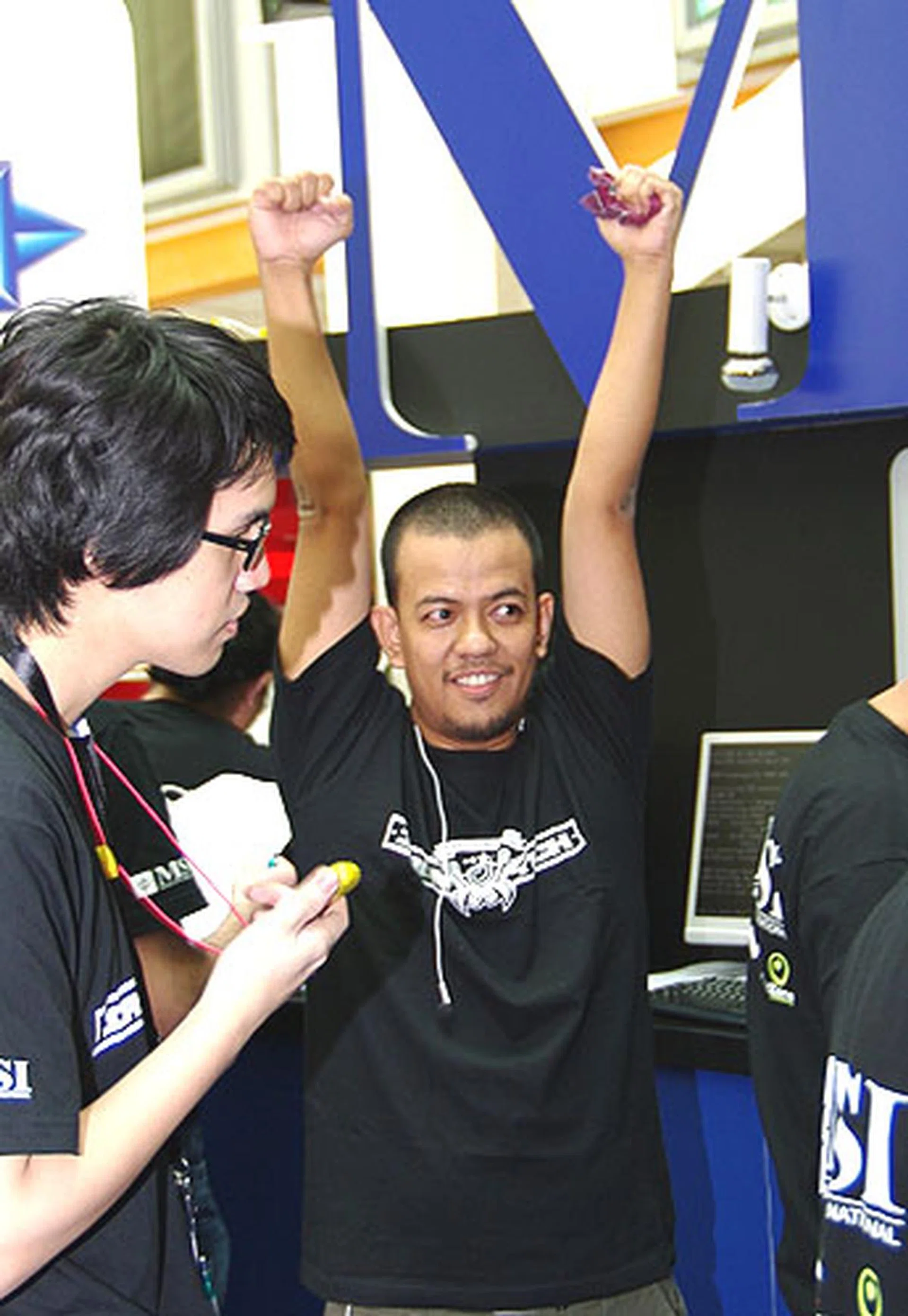  Ronaldo Bejarin from the Philippines raising his arms to cheer his third place finish for the rigging phase.  