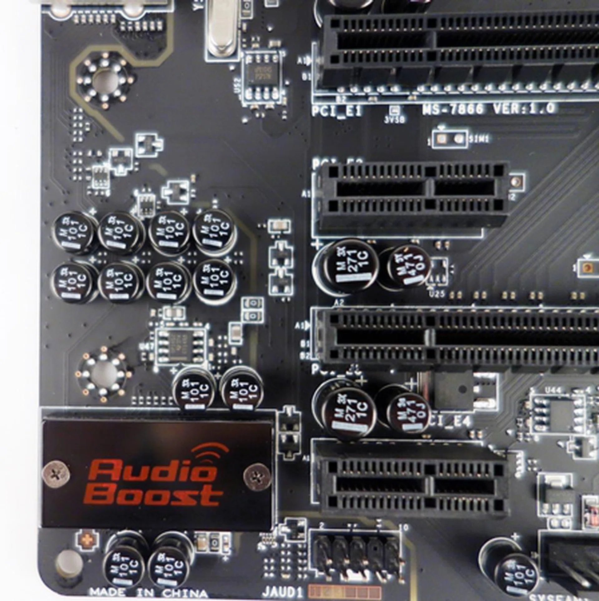 In the vicinity of the Audio Boost EMI shield for the Realtek audio chip, we see a scattering of audio capacitors (in black) that will amplify and filter the audio signals before they are routed to the audio ports.