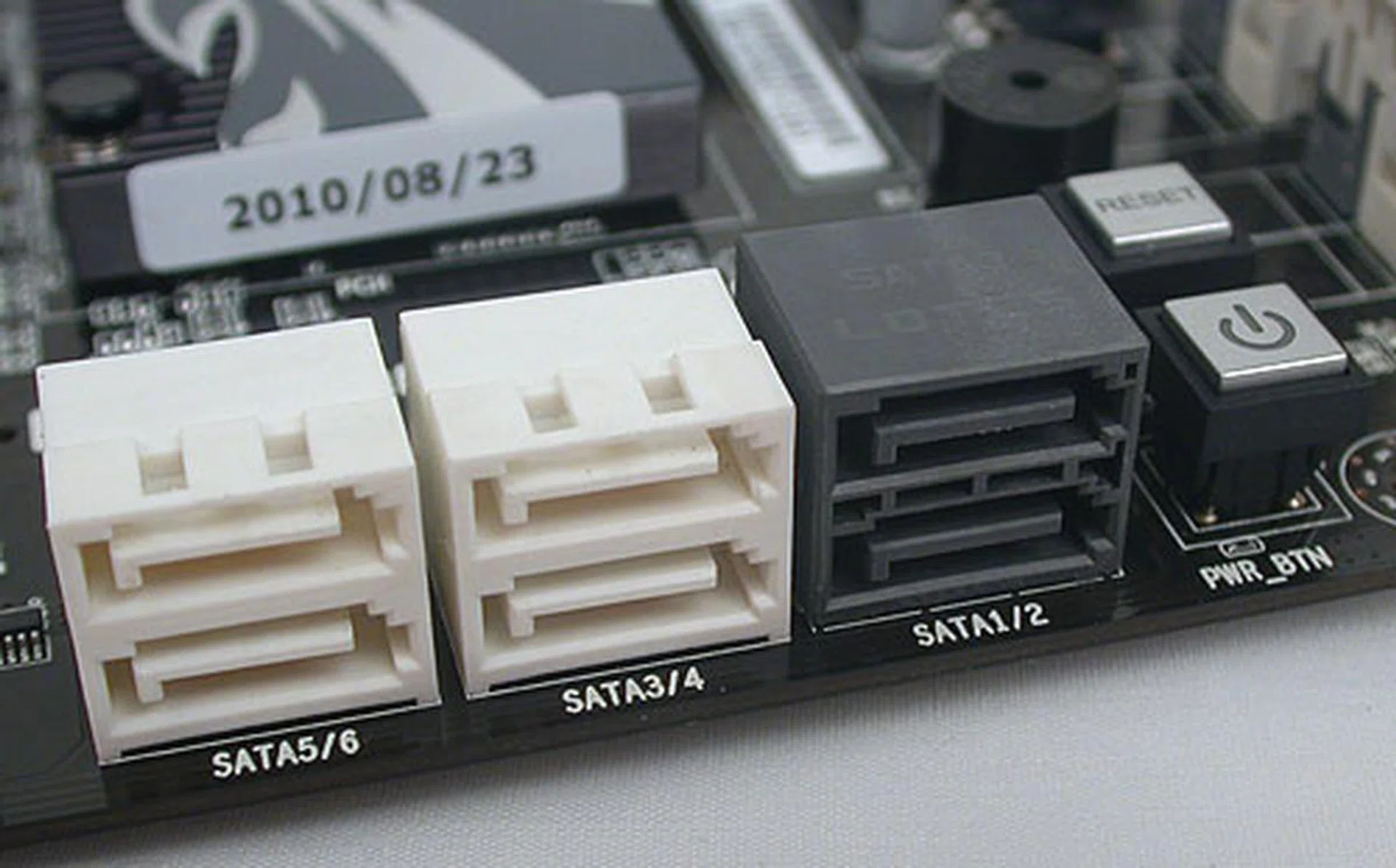 All six of these SATA ports, including the two SATA 6Gbps ones in black, are from the Intel P67 chipset and aligned the way we preferred. Power and reset buttons are also found nearby.
