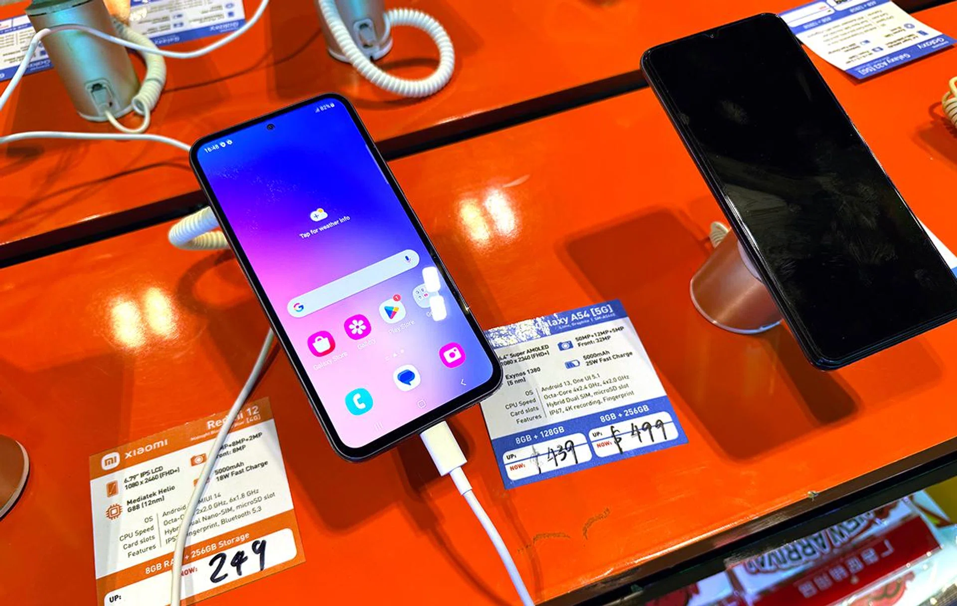 Samsung Galaxy A54 (left, display on).