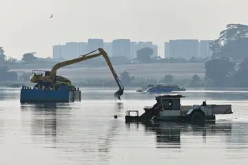 Harvesters removing aquatic plants from Lower Seletar Reservoir.