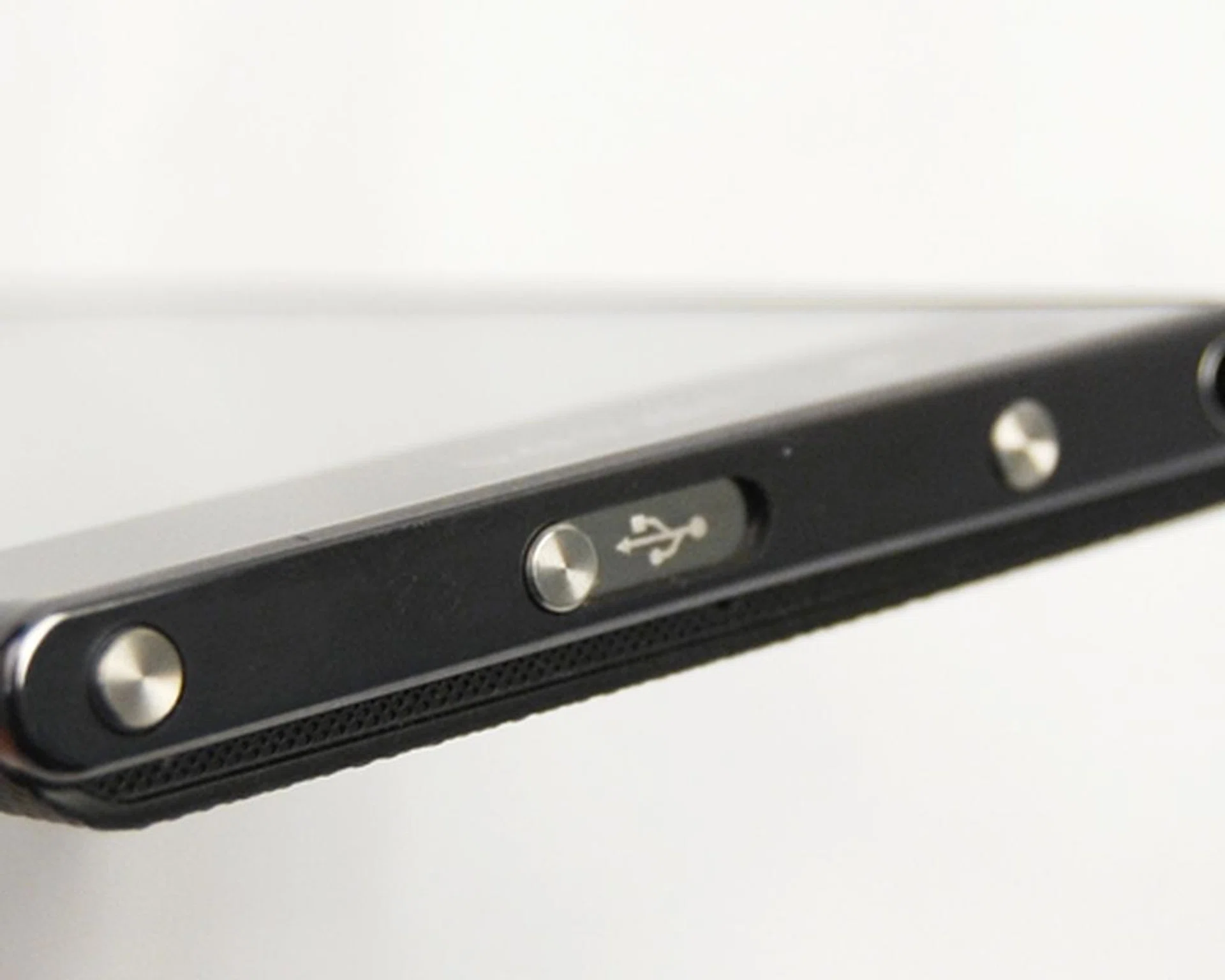 We love the sliding cover for the micro USB port, though we can't say the same for the odd placement of its camera button on the top of the device.