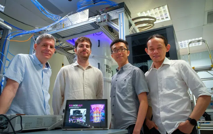 (left to right) NTU Assoc Prof Rainer Dumke with his other co-founders of AQSolotl, Chief Executive Officer Mr Patrick Bore; Head of Quantum Algorithms Mr Paul Tan; and Chief Technical Officer Dr Yap Yung Szen, who is also a Senior Lecturer at the Universiti Teknologi Malaysia. The start-up’s flagship product, Chronos-Q, can be seen at the top right corner of the quantum computer at NTU. Photo: NTU. 