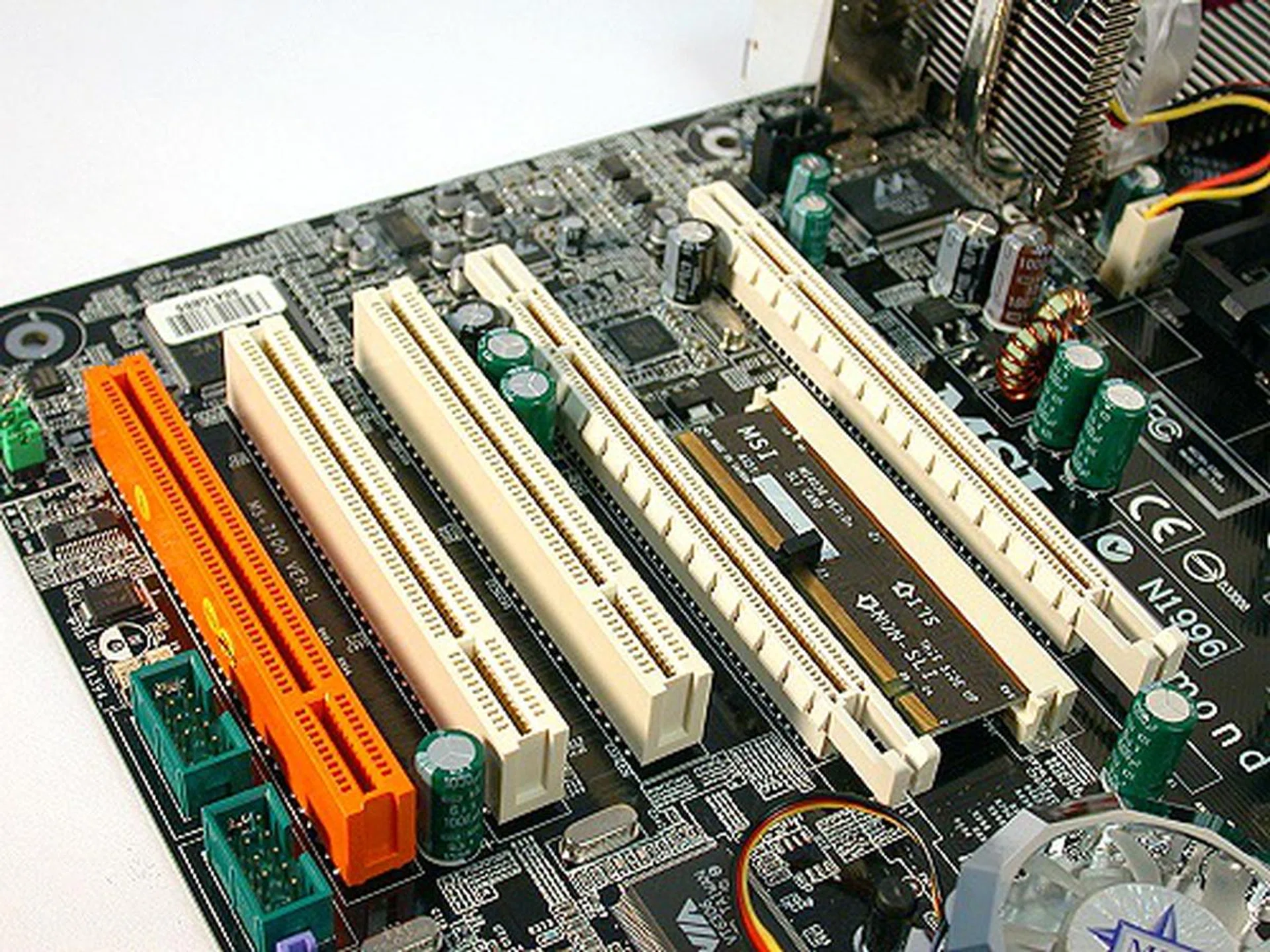 The two longer slots shown here are the dual PCI Express x16 slots for SLI and sandwiched in between them is the SLI switch. Yes, it was not as simple as plugging in both cards and expecting it work, at least not initially. 