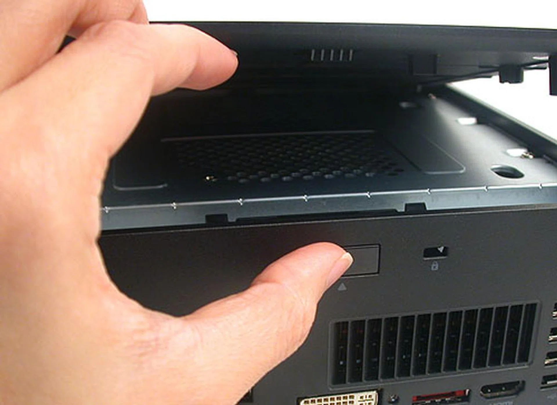 Push hard enough on this switch to spring open the plastic top to access the interior of the PC.