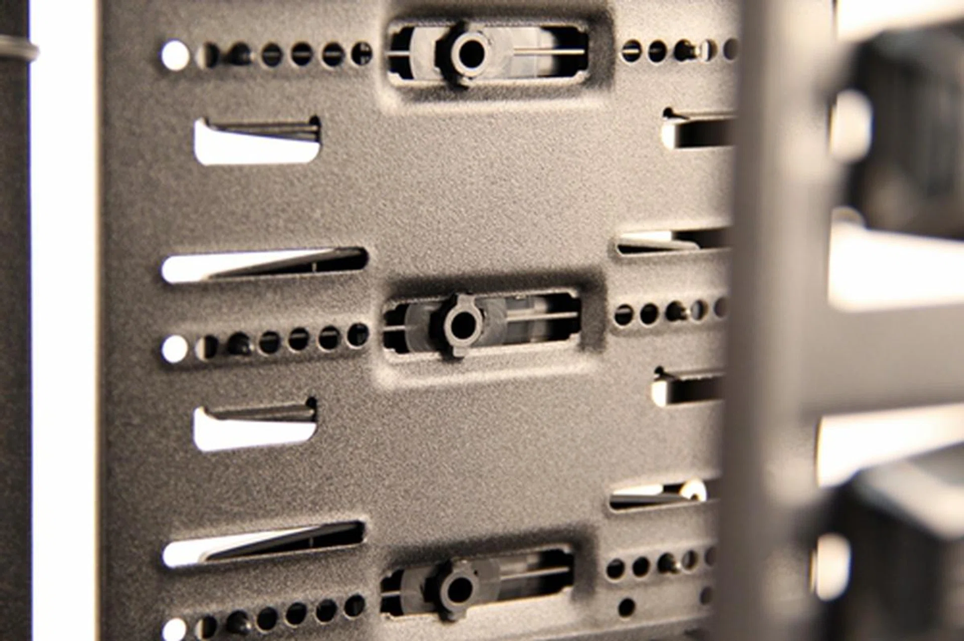 The installed retaining clips are shown here with an inner view of the drive cage; you can see their center fastening stubs in locked position.