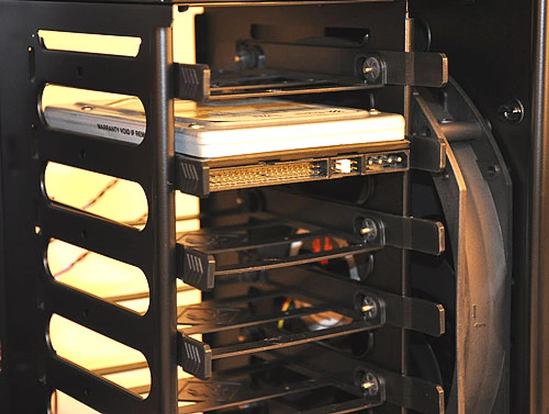 A rather standard arrangement with the 2.5-inch drive bays for your storage. We easily installed our HDD by snapping the holders to the drive. Easy to remove and to install. And you can route the cables from below the motherboard since it's an open design.