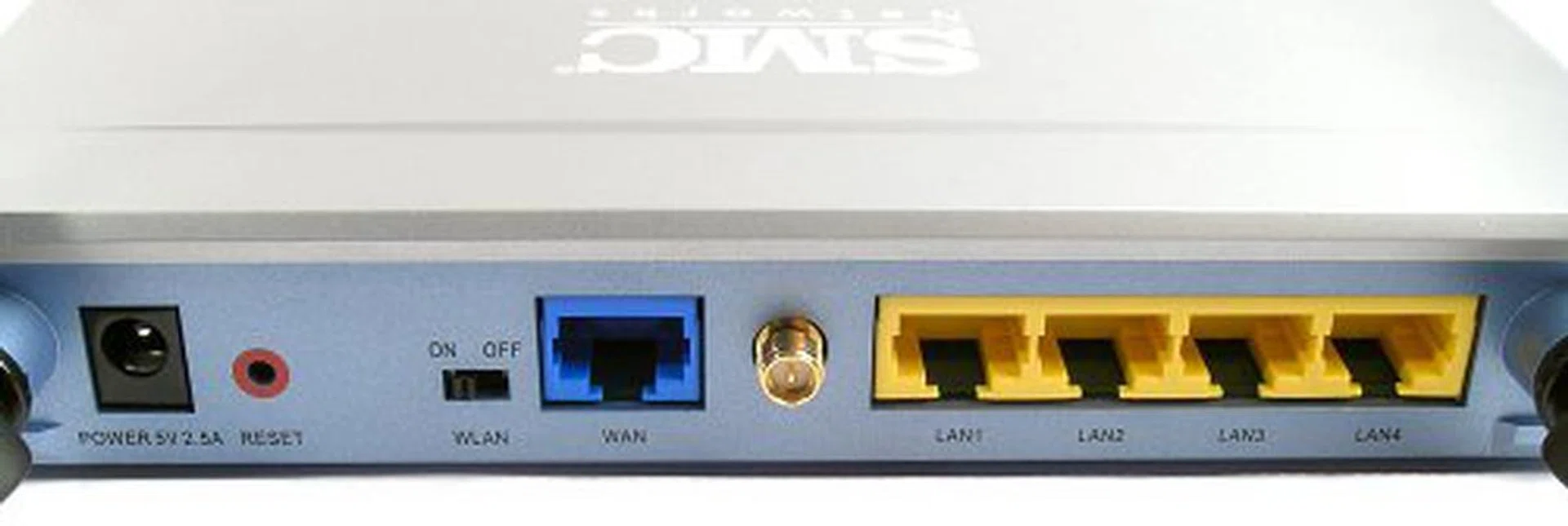 From left to right - Power input, Reset button, WLAN switch, WAN port, Antenna connector, four Fast Ethernet ports.