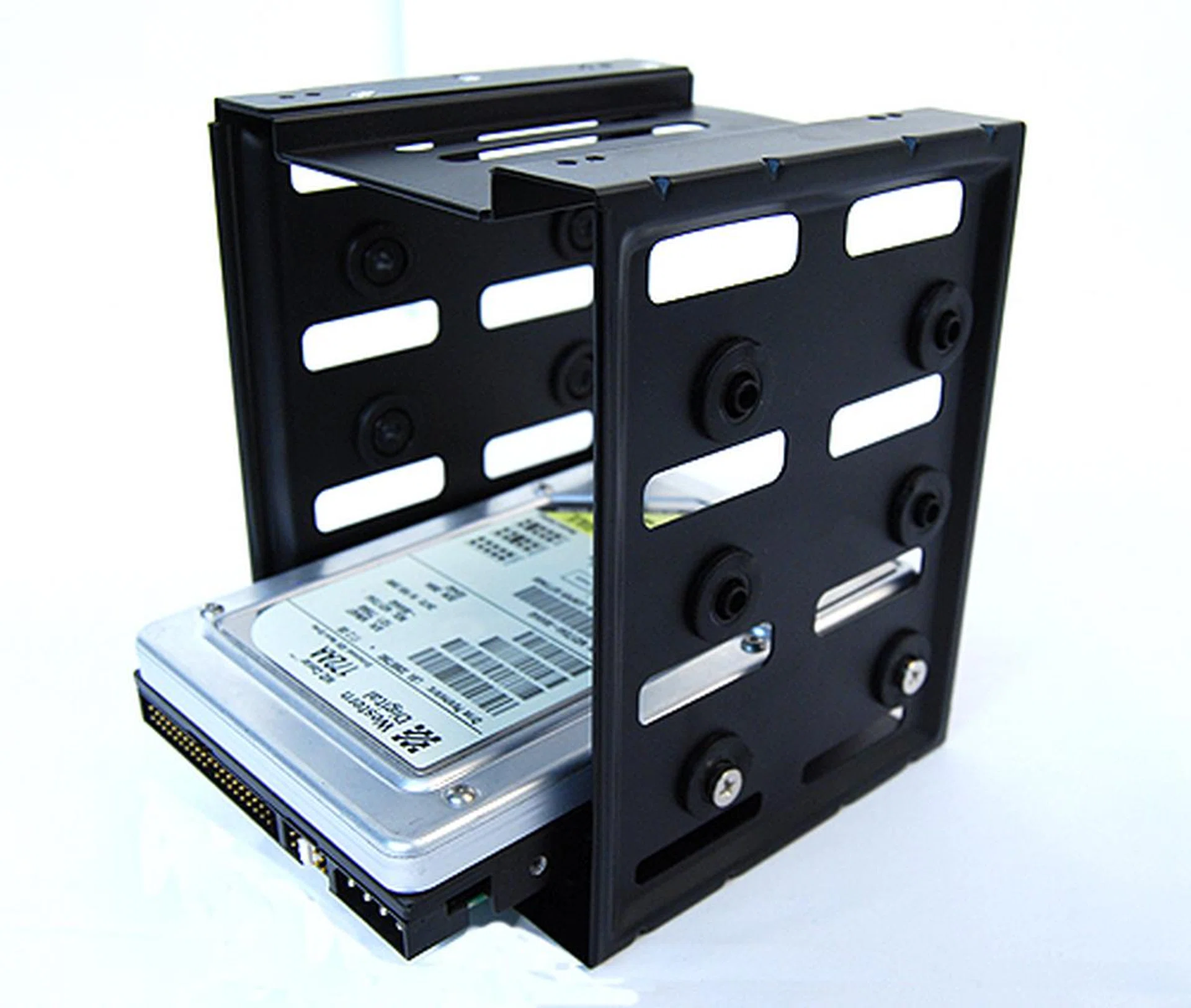 The drive cage has space for only three 3.5-inch hard drives. To fit the drives into the cage, you'll need to turn some screws. Note that the mounting holes come with rubber grommets installed.