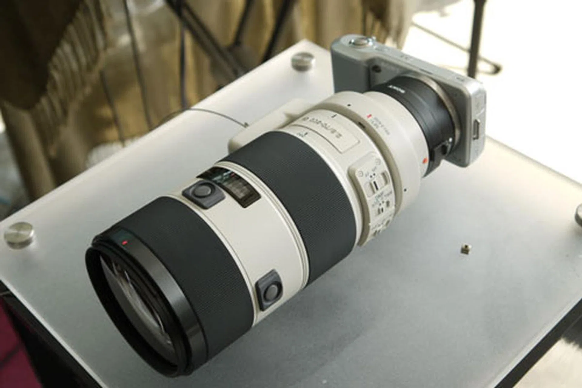 An NEX-5 with a Sony Alpha 70-200mm lens and E-mount adapter.