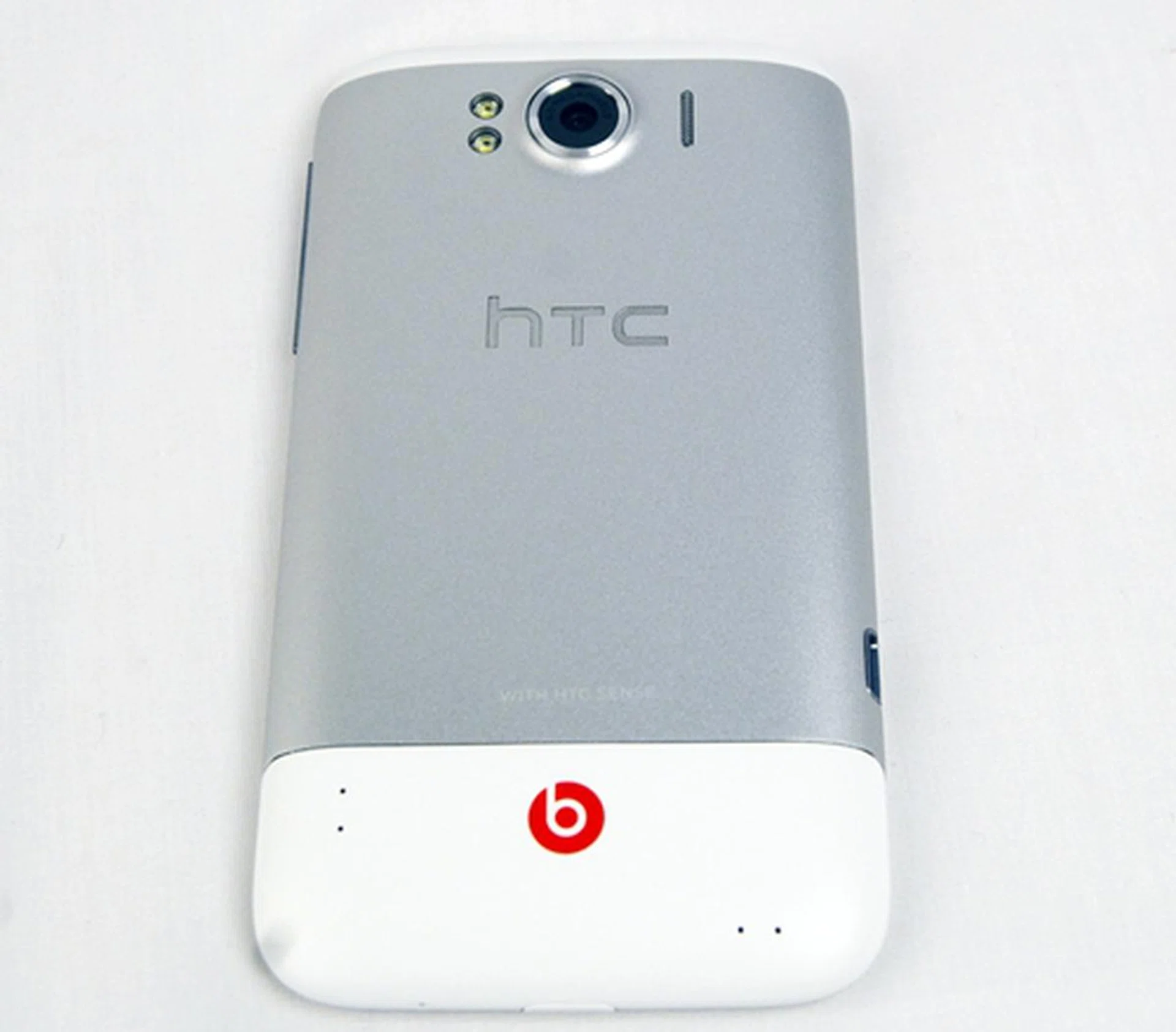 The striking red logo of Beats by Dr. Dre stands out on the white chassis of the HTC Sensation XL. Near the top, you can find the 8-megapixel camera which is flanked by the dual-LED flash on the left and speaker grille on the right.