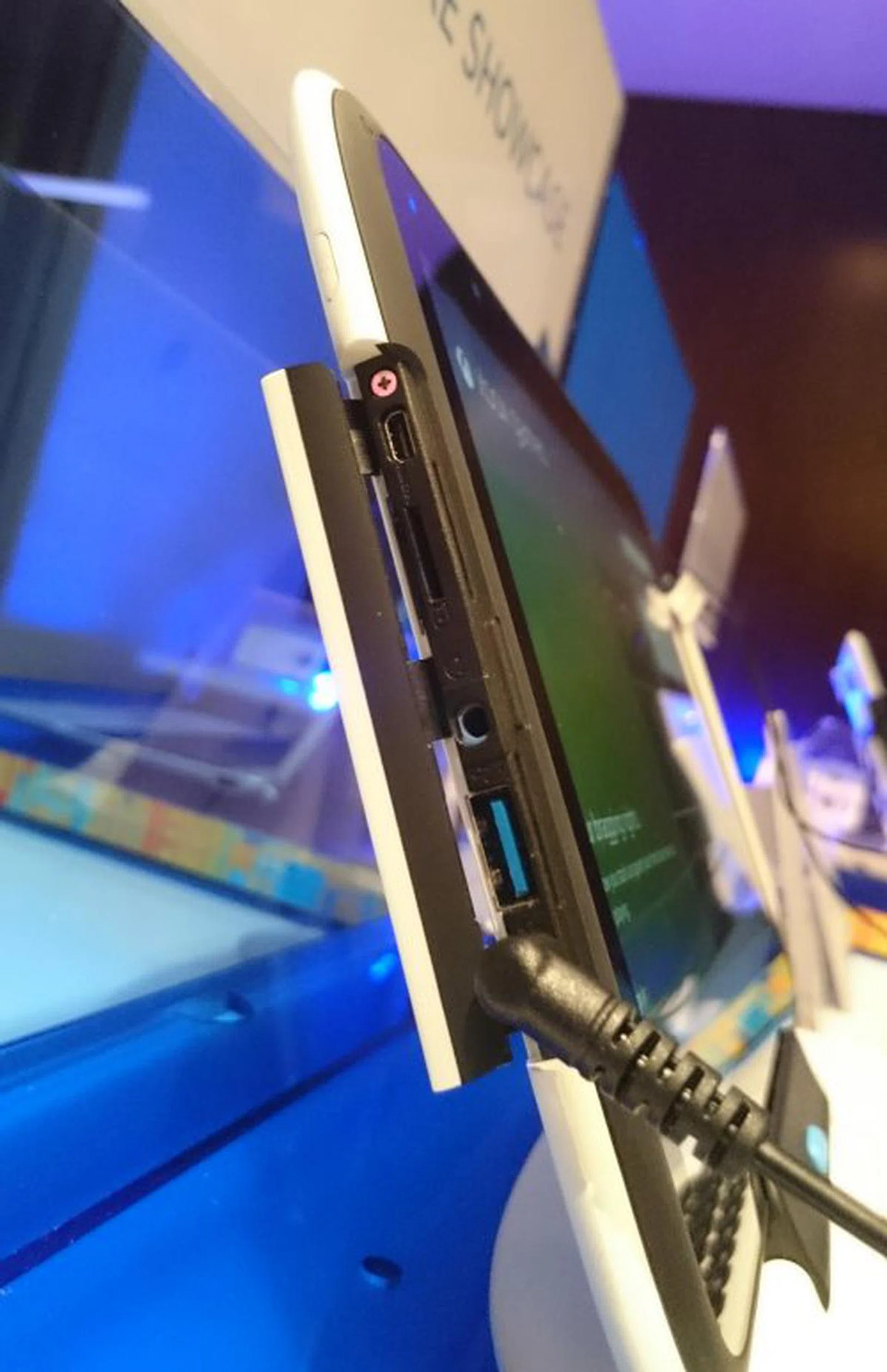 Notice that the ports are concealed behind a seal. Video output, memory card, headphone jack and USB 3.0 ports are available.
