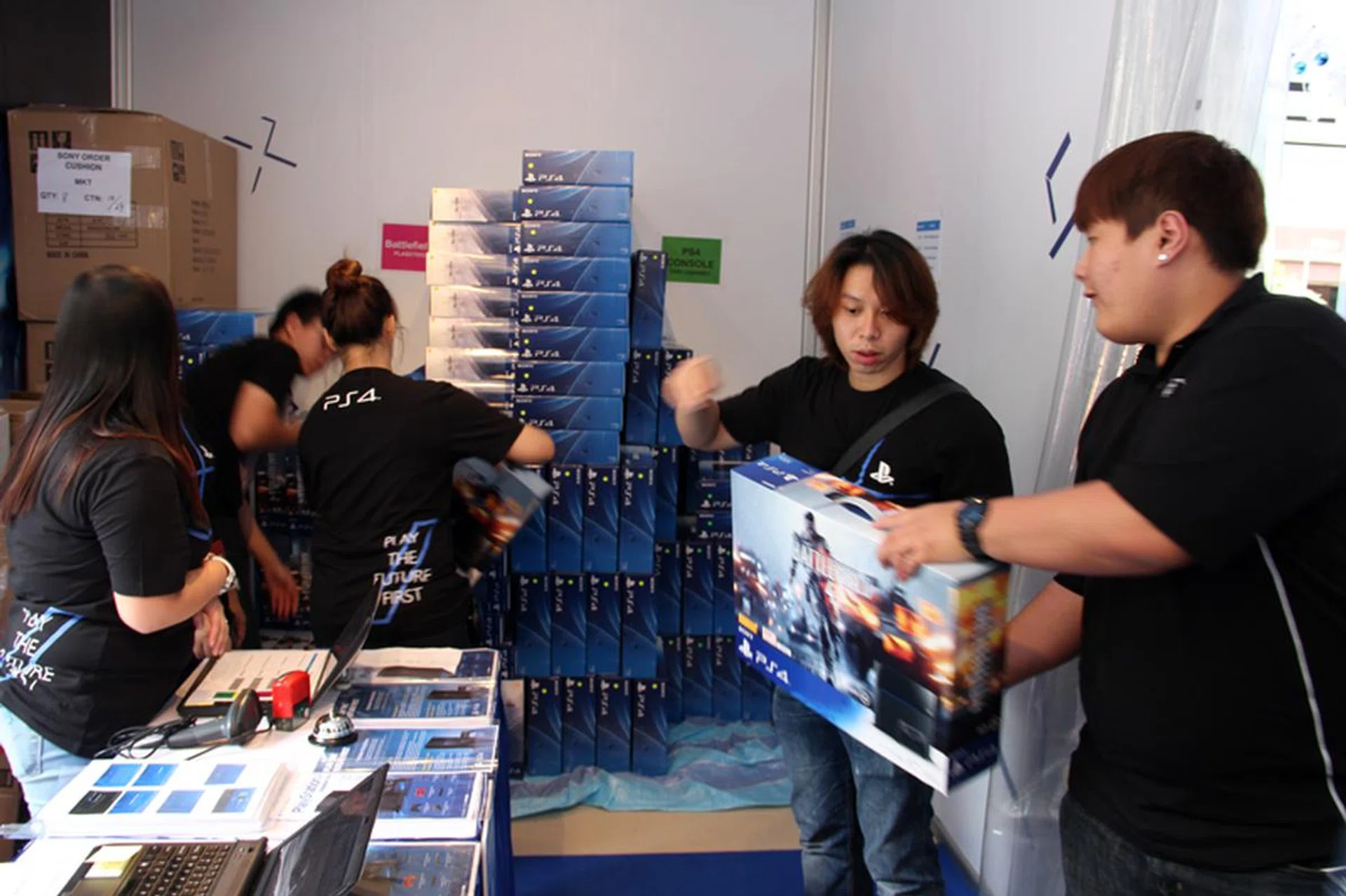 The Sony staff hard at work unloading all of the PS4 pre-order sets.