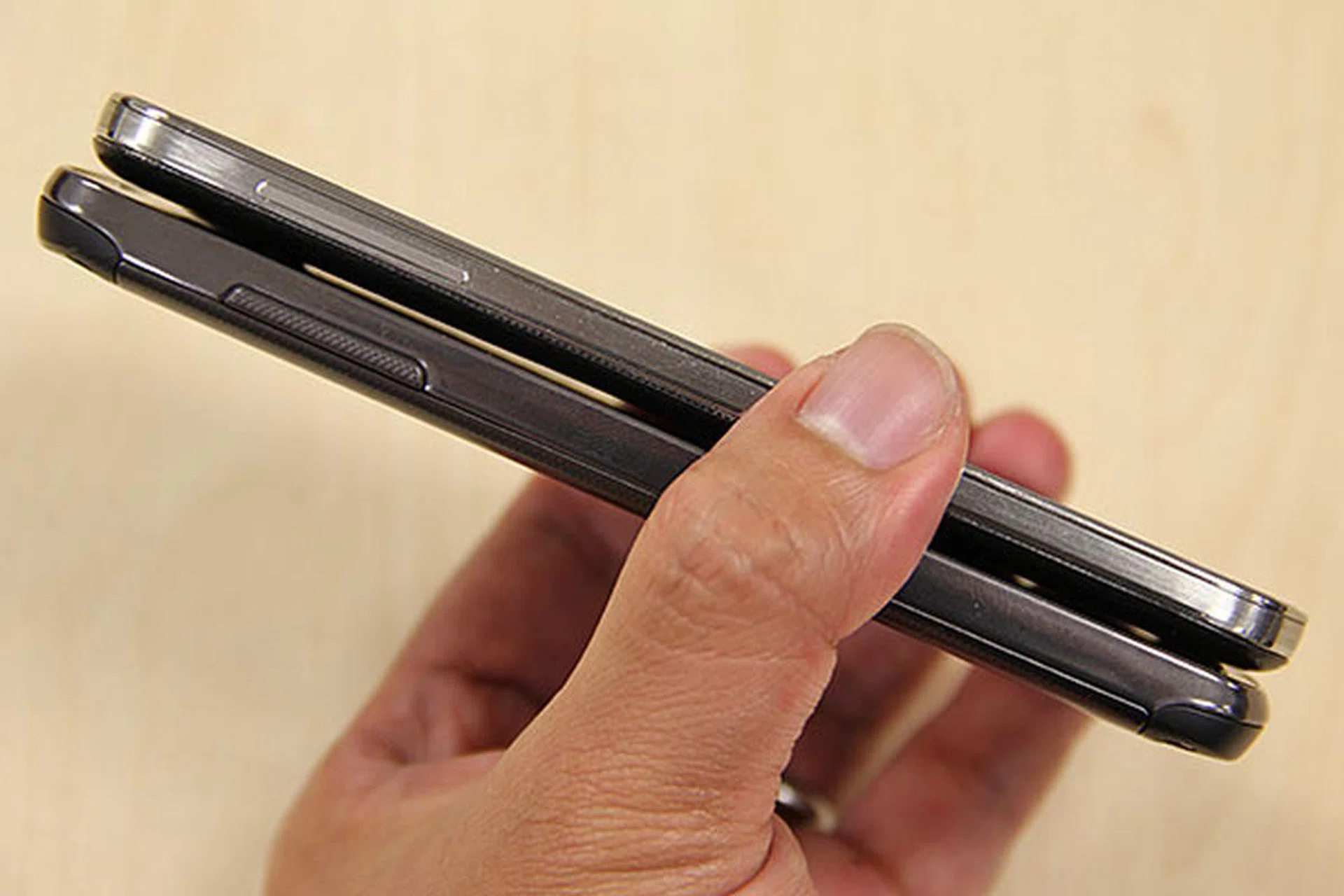 On paper, the Galaxy S4 Active (bottom phone) is bigger and thicker than the S4 (139.7 x 71.3 x 9.1mm vs. 136.6 x 69.8 x 7.9mm). It's 23g heftier too.