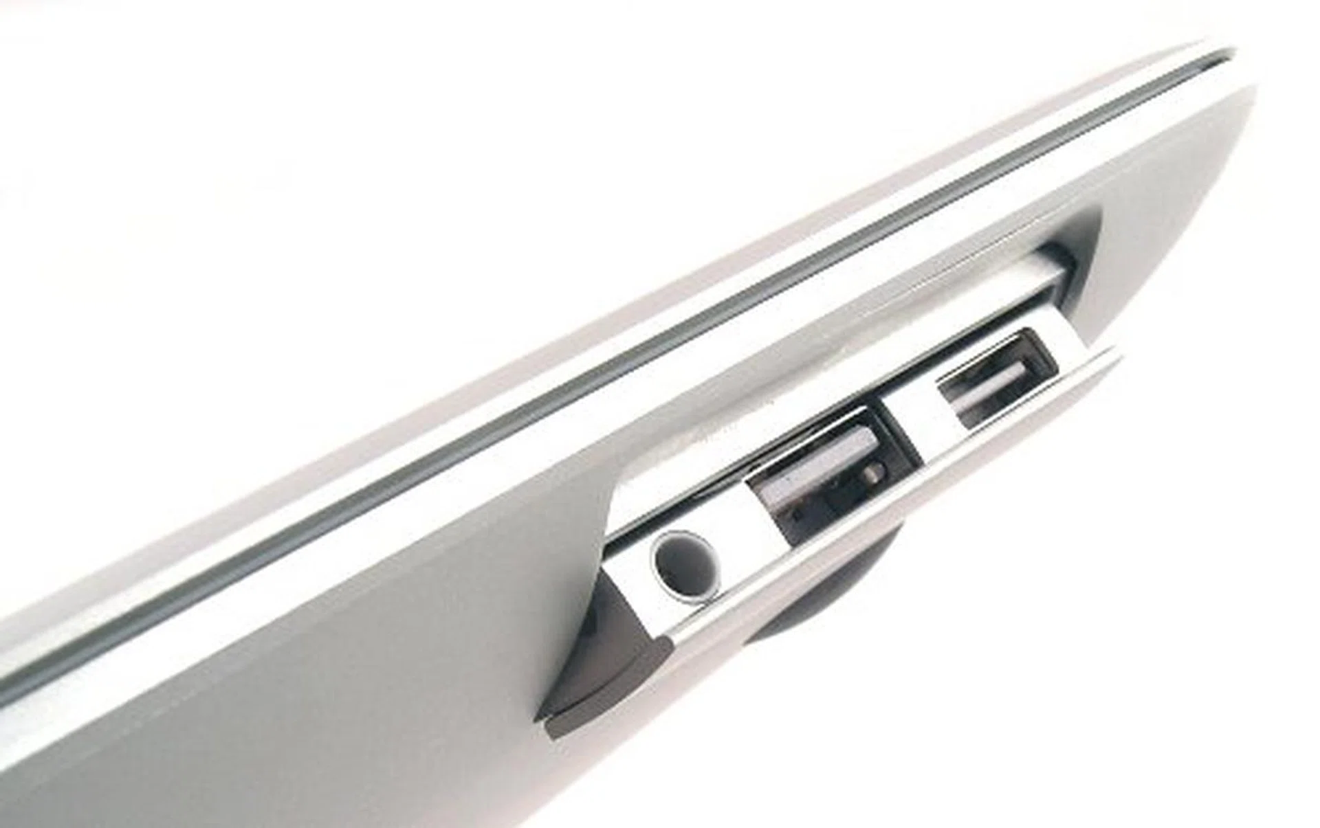 Hidden flip panel reveals the only three ports available to the MacBook Air.