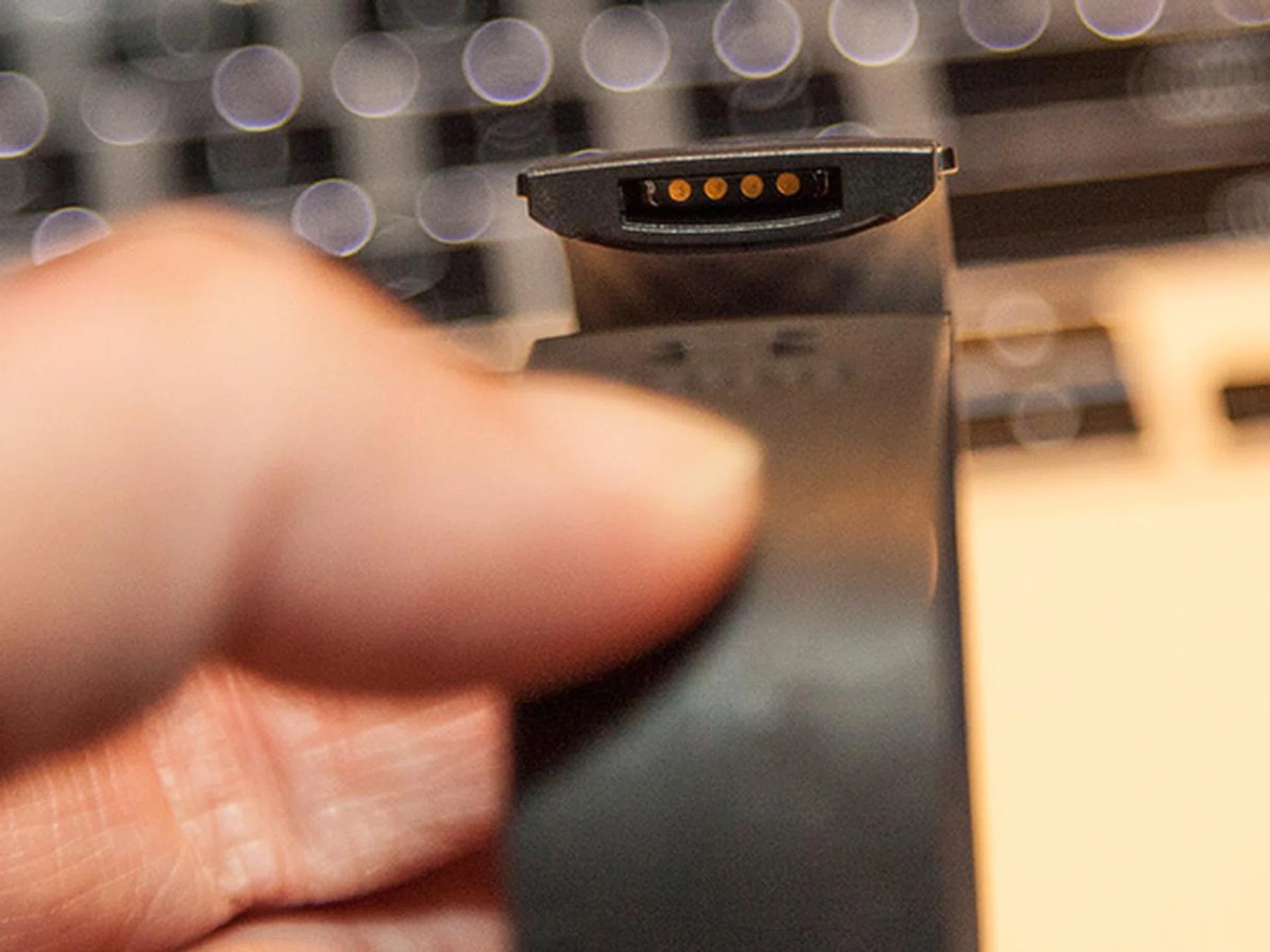 The charging port is located at the clasp end of the band.