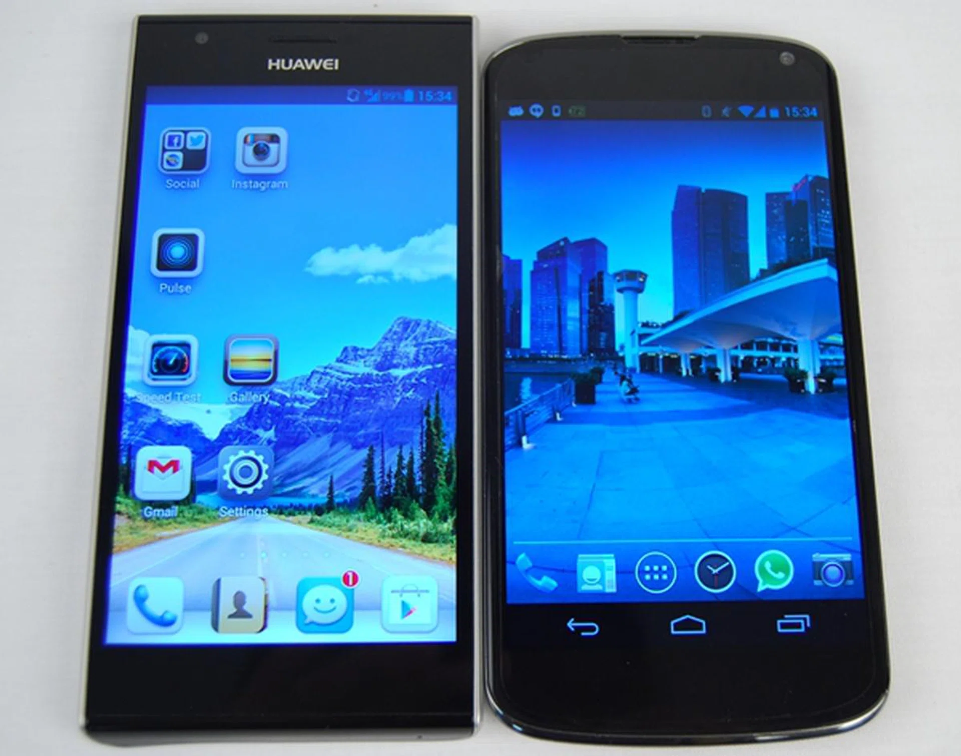 The Huawei Ascend P2 (left) may be longer than the LG Nexus 4 (right), but being narrower and lighter makes it as portable as other phones of its class.