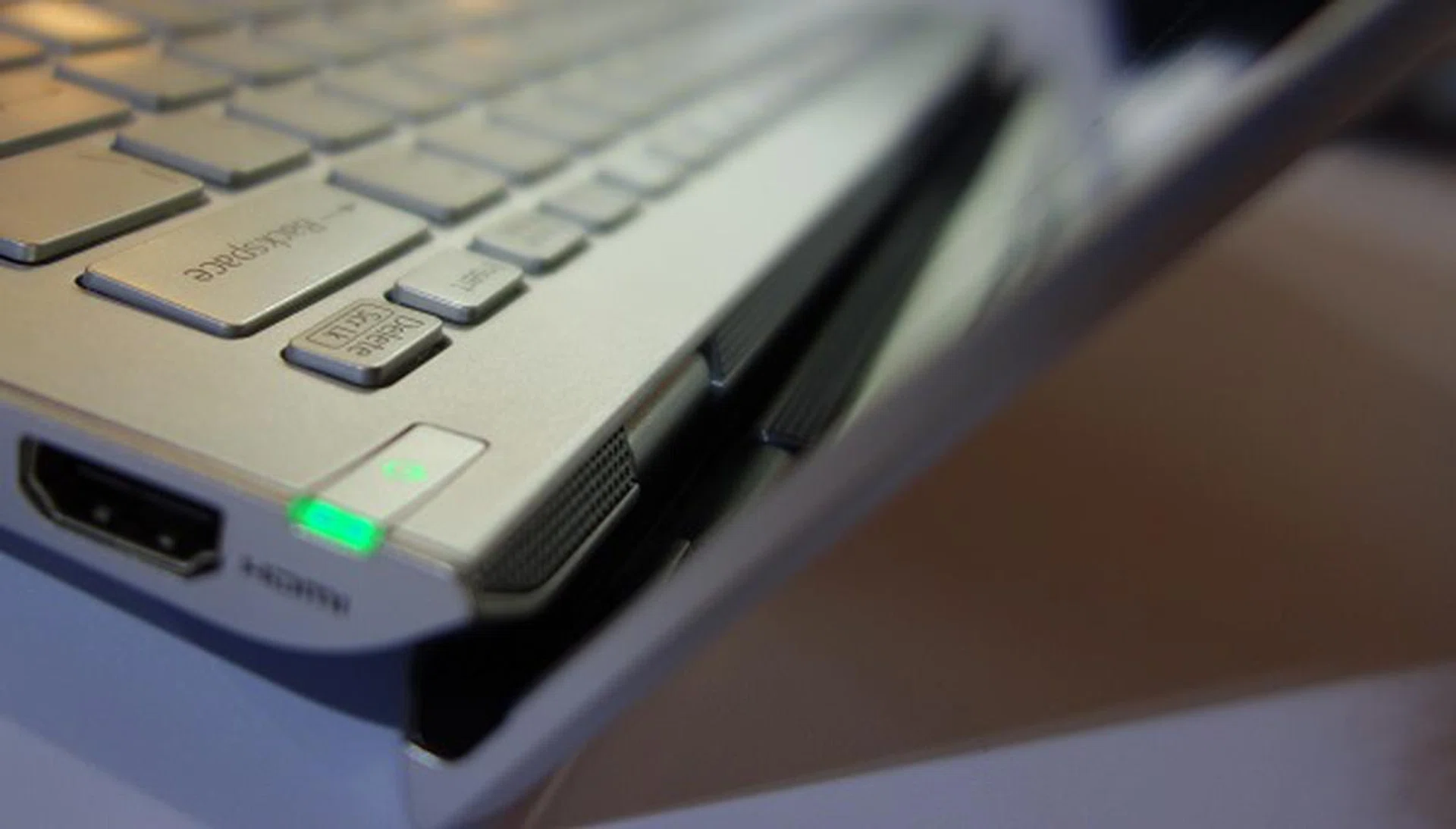 The speakers are cleverly hidden along the edge where the display panel hinges are, angled in such a way that the emitted sound waves reflect off the display panel and towards the user.