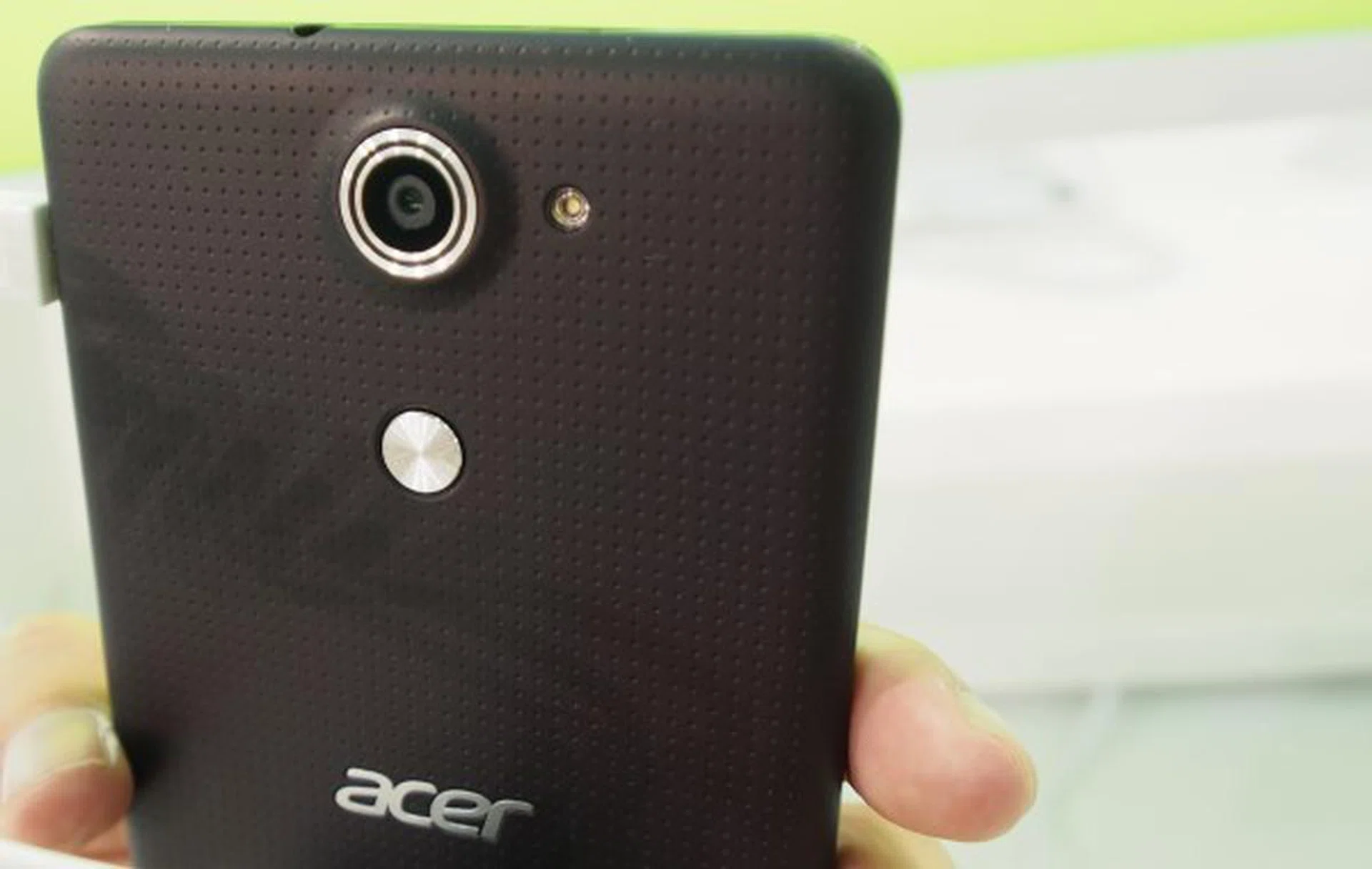 The rear plastic casing is dimpled. Below the camera is the AcerRAPID shortcut key.