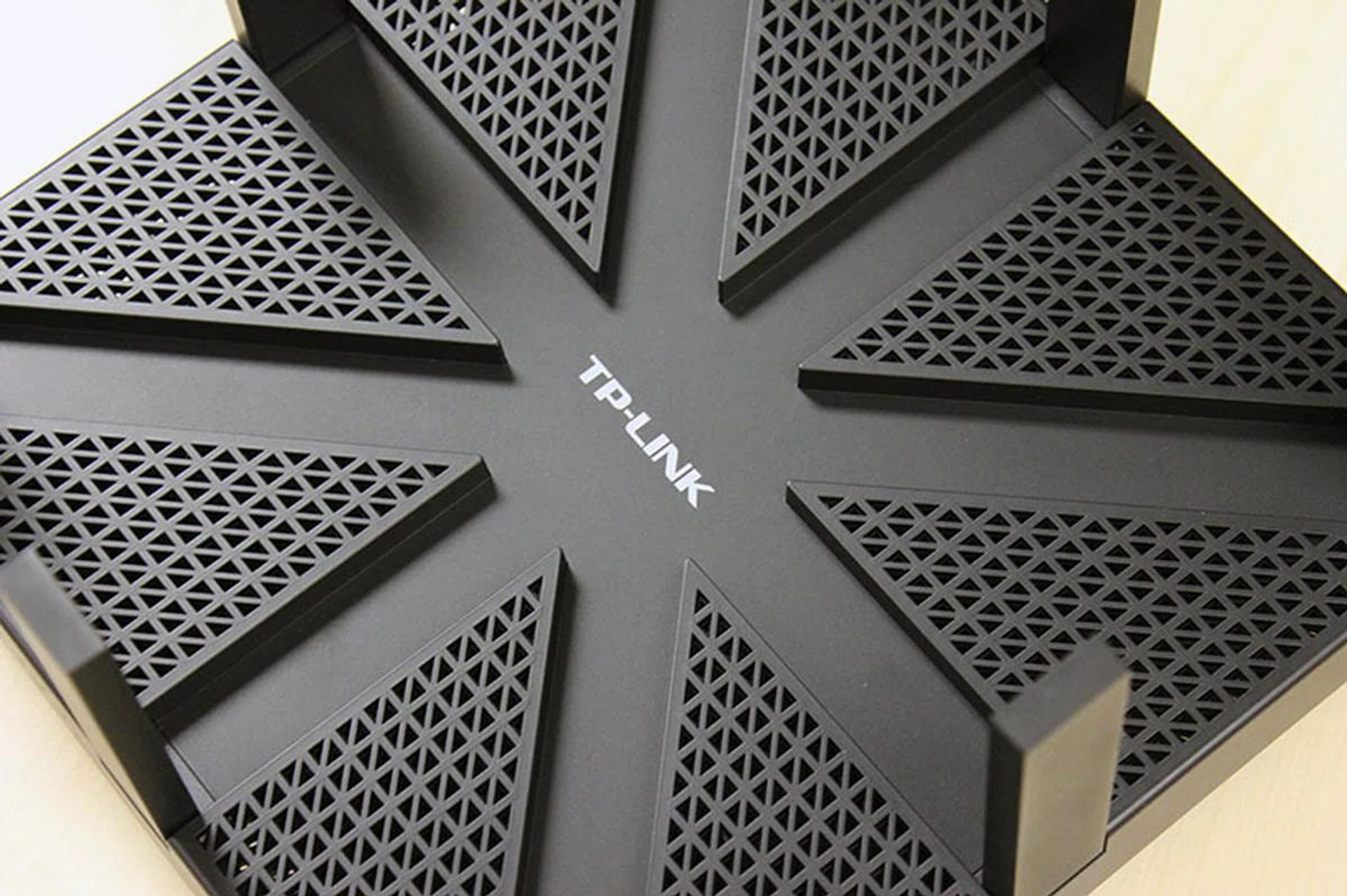 The top panel features cut-outs for the antennas to fold into. There are also countless vents to help keep the router cool.