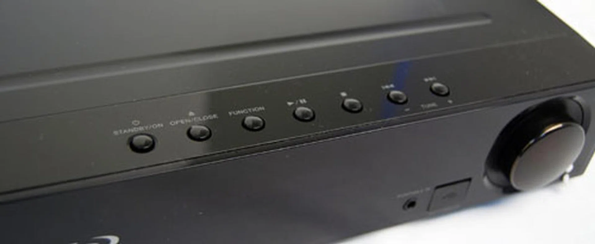 Standard buttons on the top right are used to power on the device and control playback.