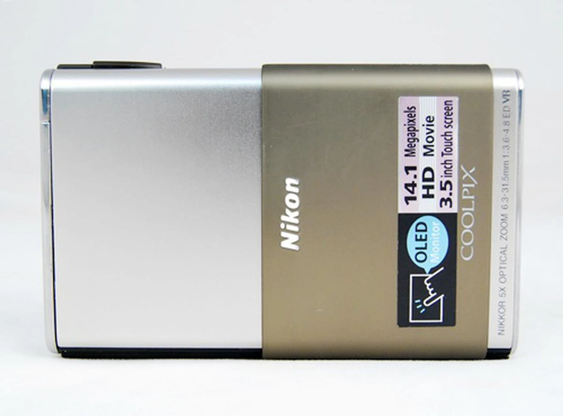 The camera is powered on by sliding the cover (which hides the lens and flash). A catch keeps the slide out cover in place.