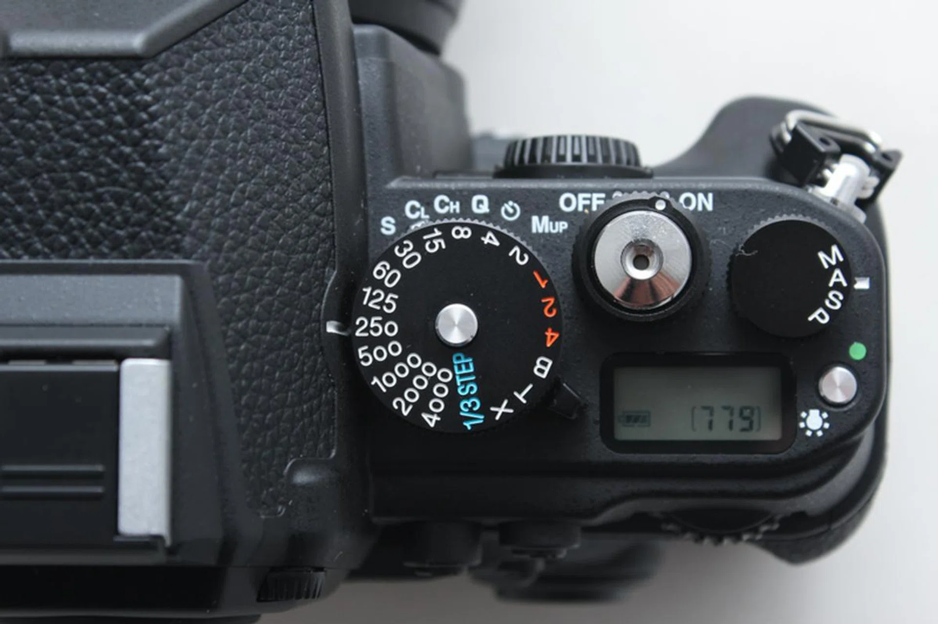 Shutter speed is set by the top dial, unless it's set to 1/3 Step in which case it's then set by the rear control dial.