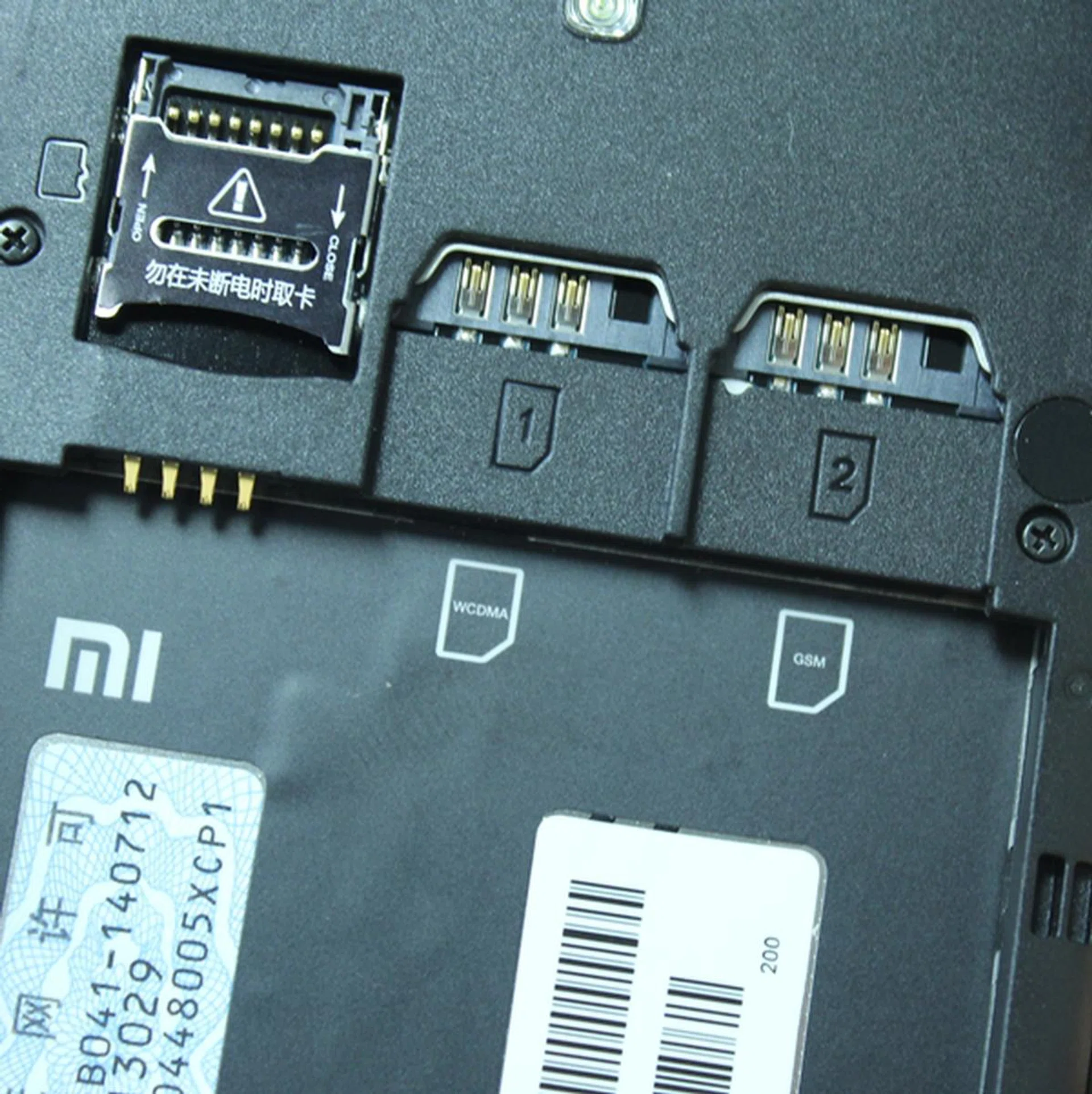 From left to right: microSD memory card slot and two regular-sized SIM card slots.
