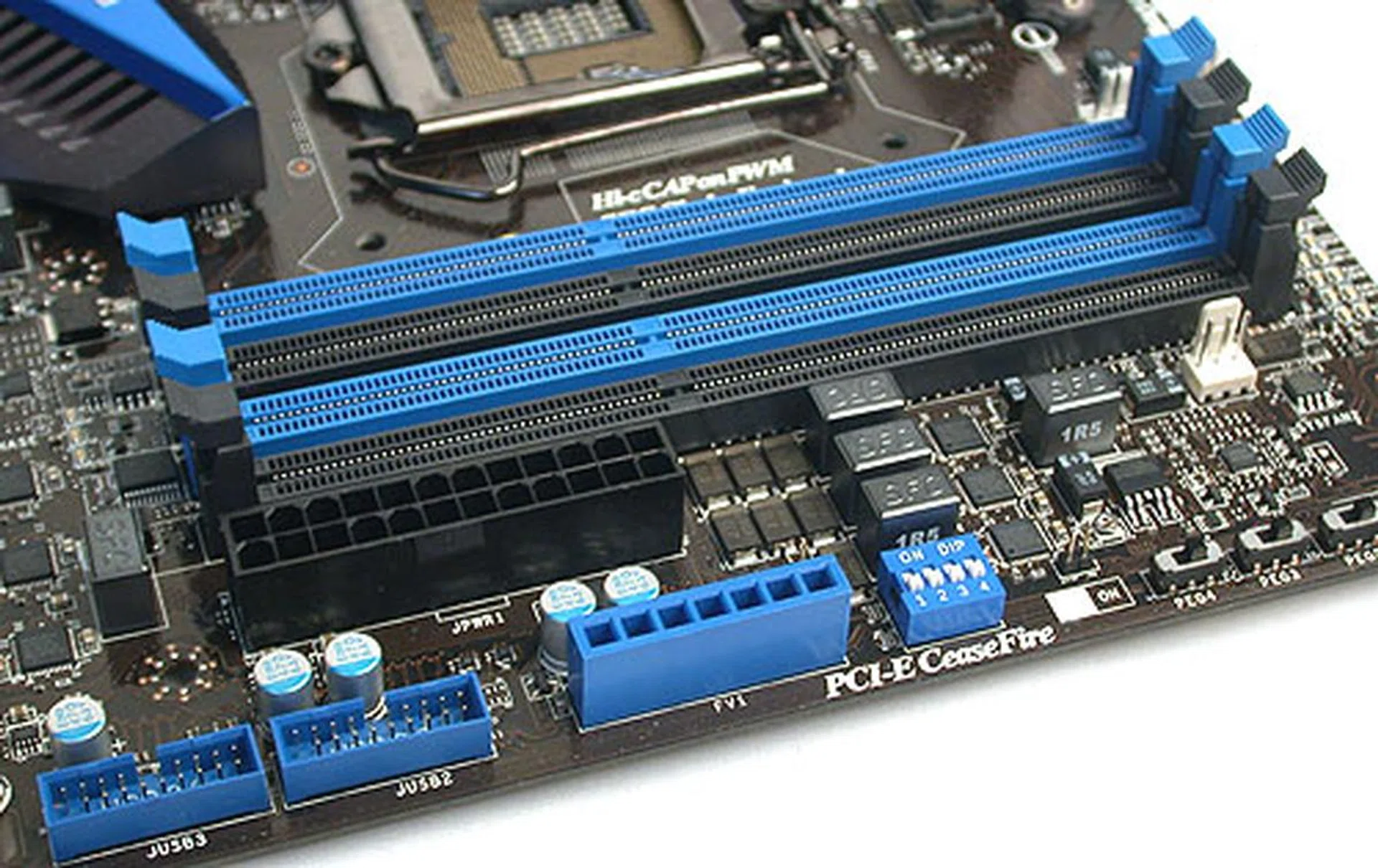 The four DIMM slots are standard for its class - 32GB max, DDR3 2133MHz. You can also see the voltage measuring points here along with the USB 3.0 headers. There's also a physical array of over-voltage switches on its right for those who wish to tweak their CPU and memory voltages without going into the BIOS. 