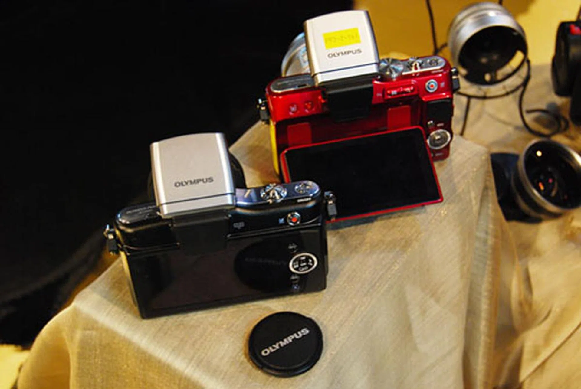 Only the E-P3 (not pictured) comes with a touchscreen, while only the PEN Lite (right) comes with a swivel screen. The smallest PEN Mini is shown on the left.