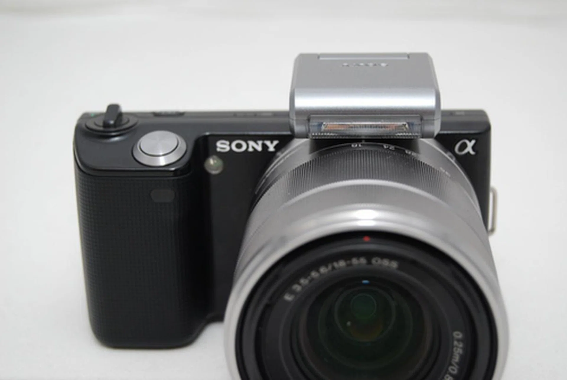 The flash attachment is unobtrusive enough that you can leave it on, but it does obstruct your hand from twisting the lens all the way round.