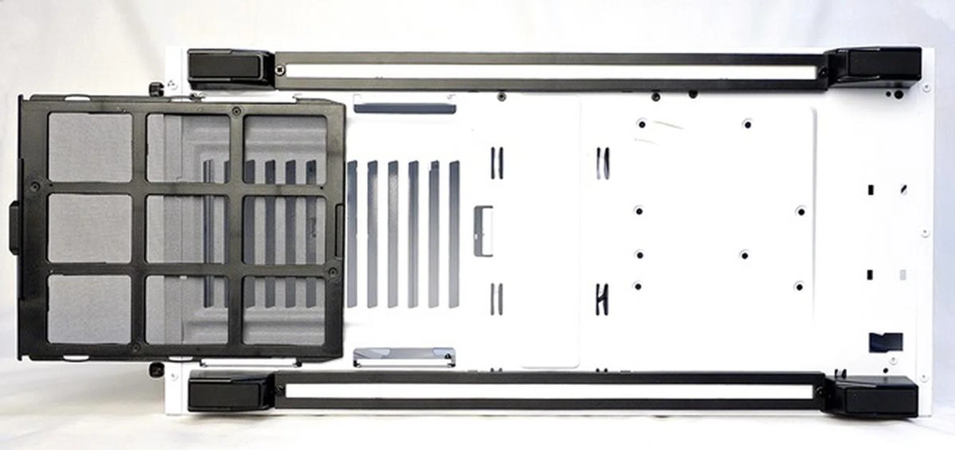 There's a removable dust filter at the bottom of the chassis to facilitate airflow out of the PSU. You can also see the rails that hold the LED mounts, which basically stretch the entire length of the case between the rubber stands of the casing.